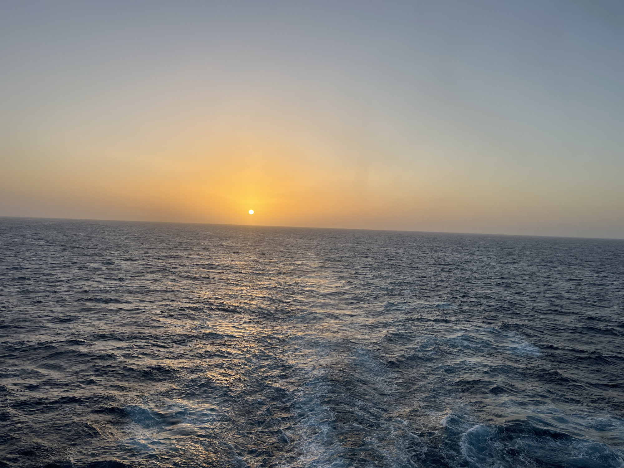 Ocean sunset observed at evening hour, golden light captured