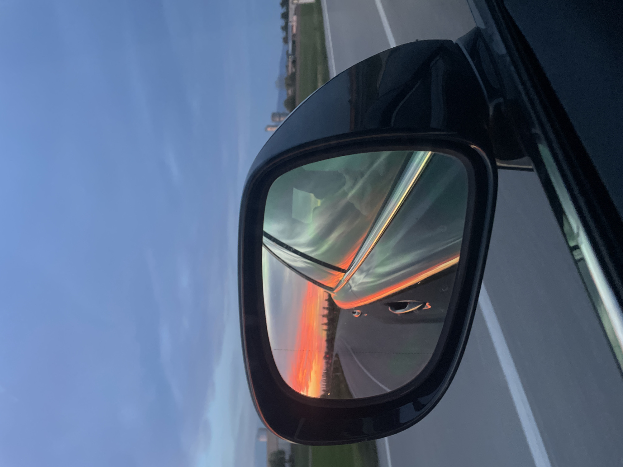 Sunset reflection captured in car mirror in San Lorenzo