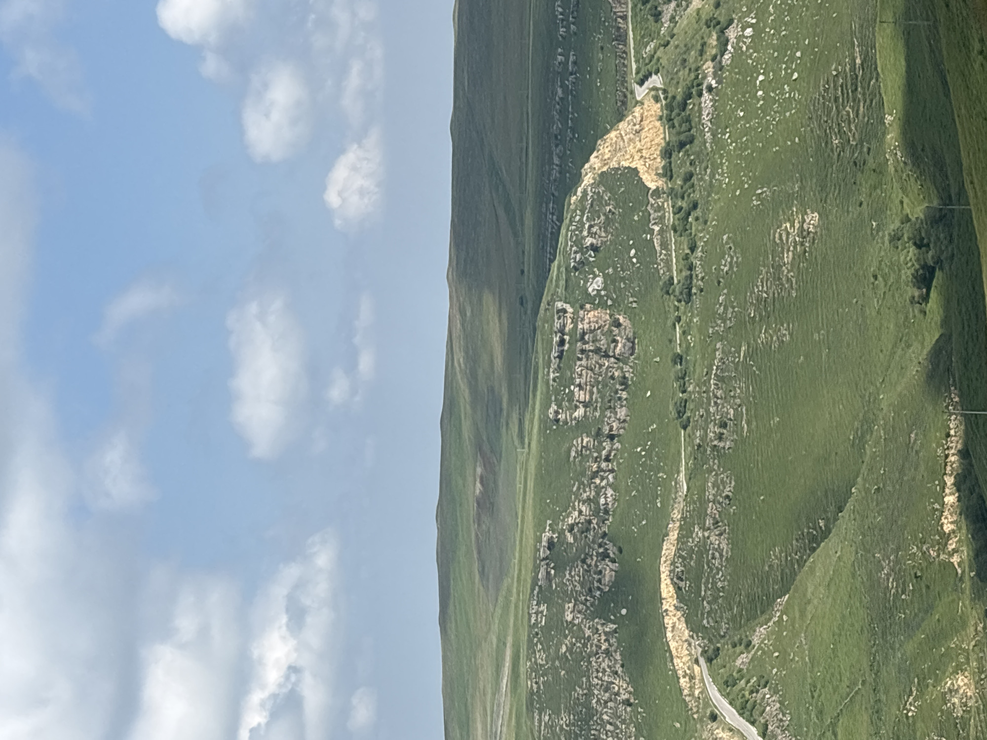 Rolling highland scenery around a quiet Russian valley village
