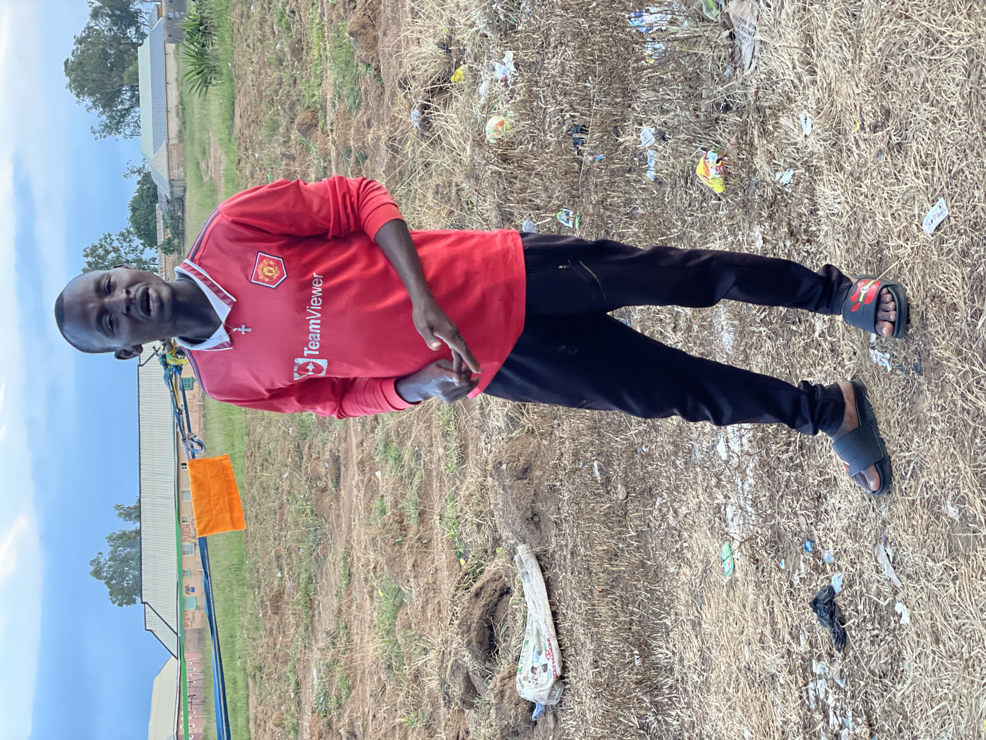 Posing in a Man United jersey across rural Nigerian fields