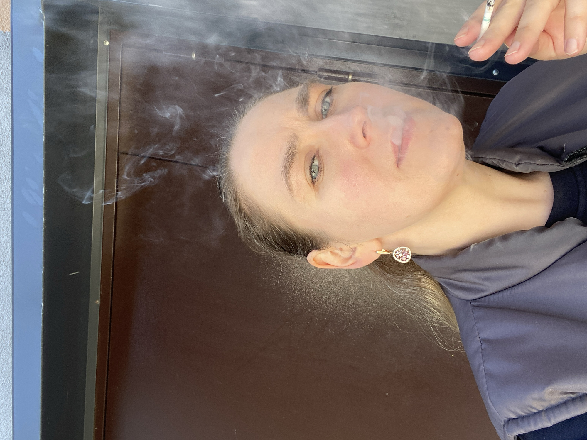 Woman smoking outside early morning in Yekaterinburg