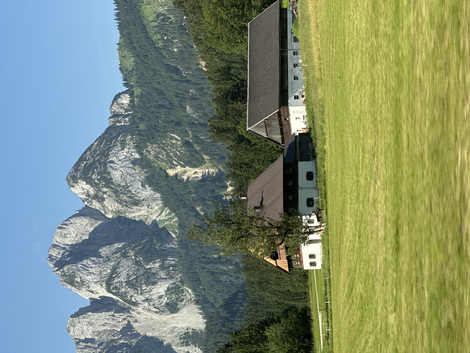 Alpine village scene in Gosau, Austria — meadows, firewood, mountains
