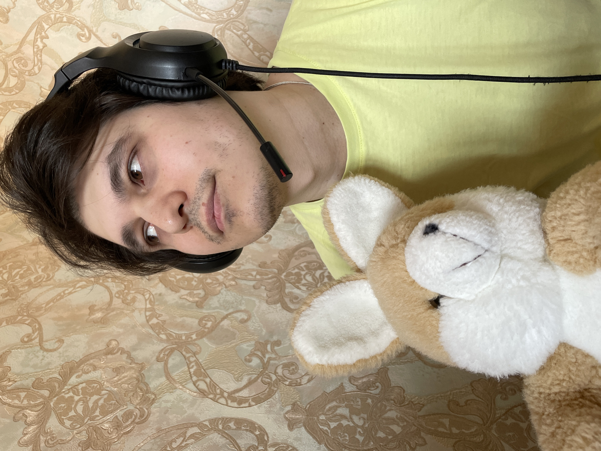 Person with headset lies beside plush rabbit in Izhevsk
