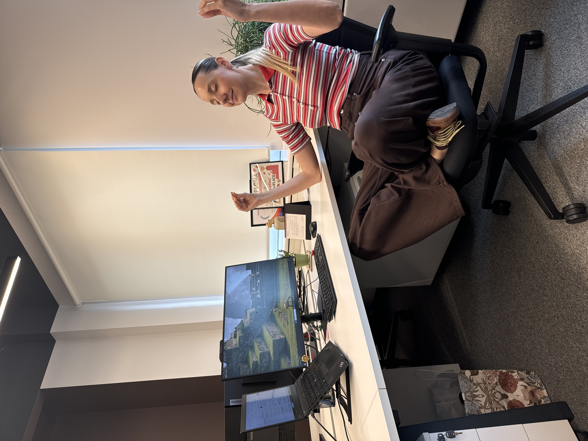 Office worker meditates at desk in Riga workplace