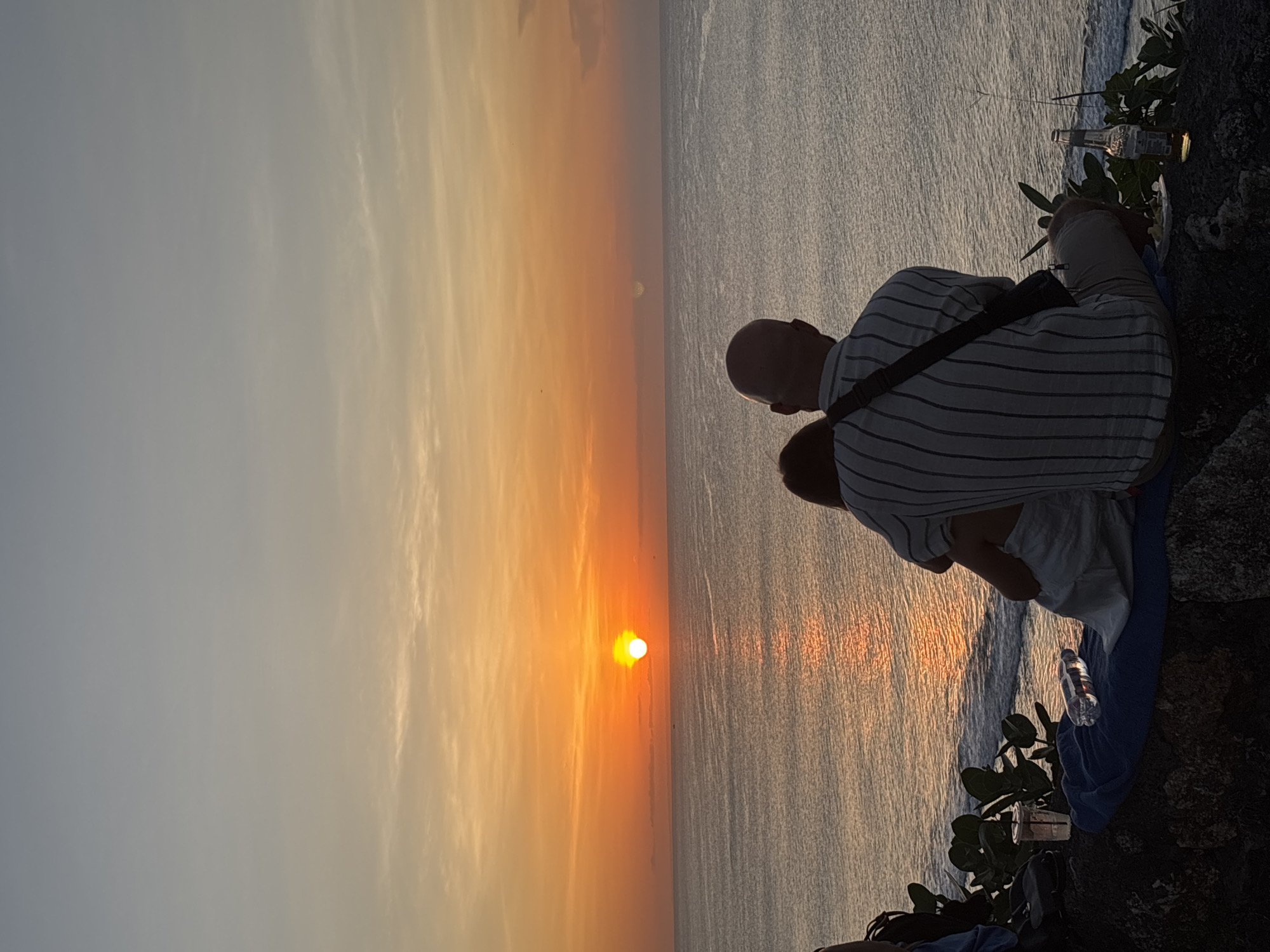 Sunset watchers gather at Uluwatu clifftops, wedding ceremony observed