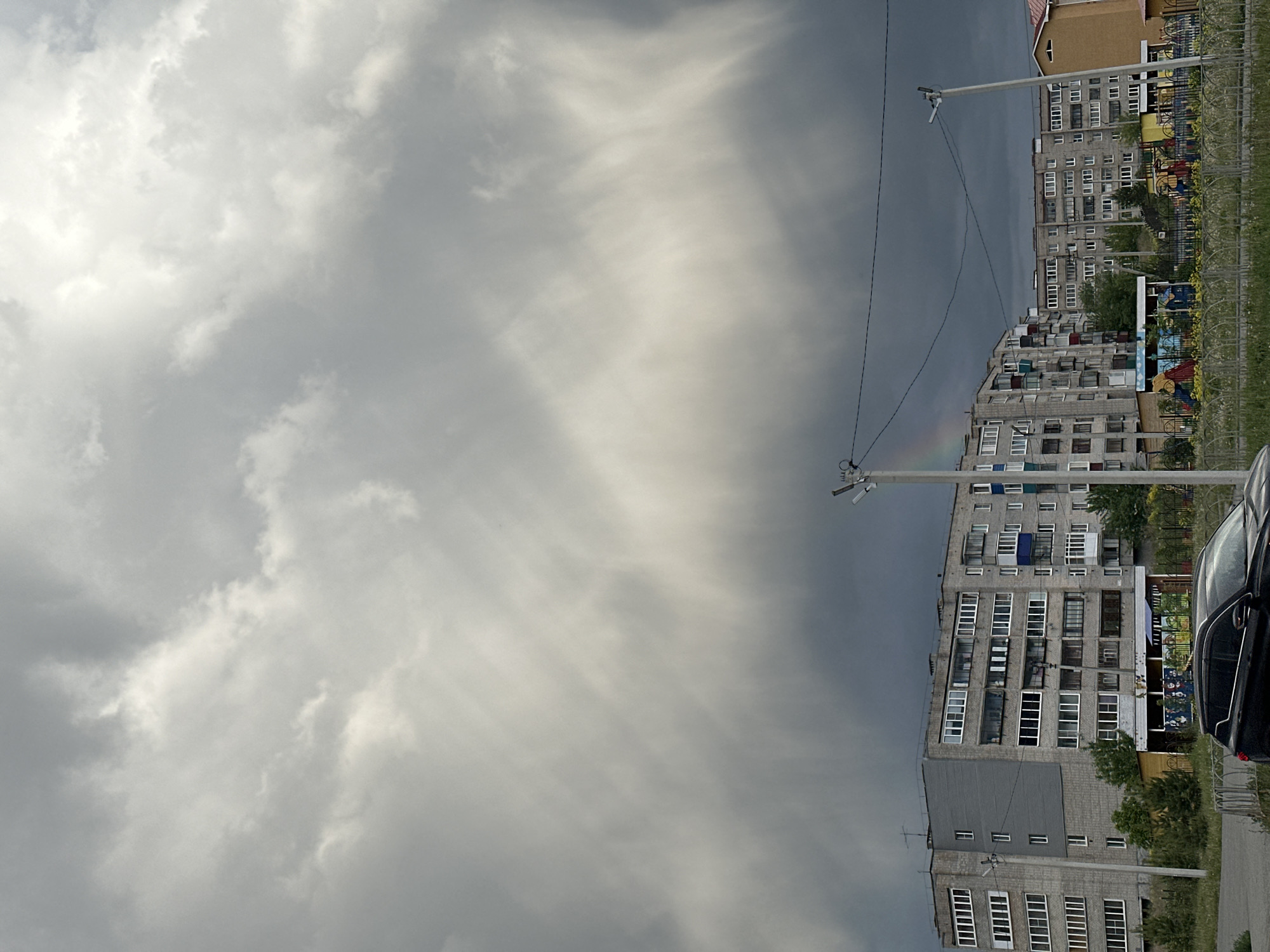 Overcast day captures Soviet-era apartments with playground area