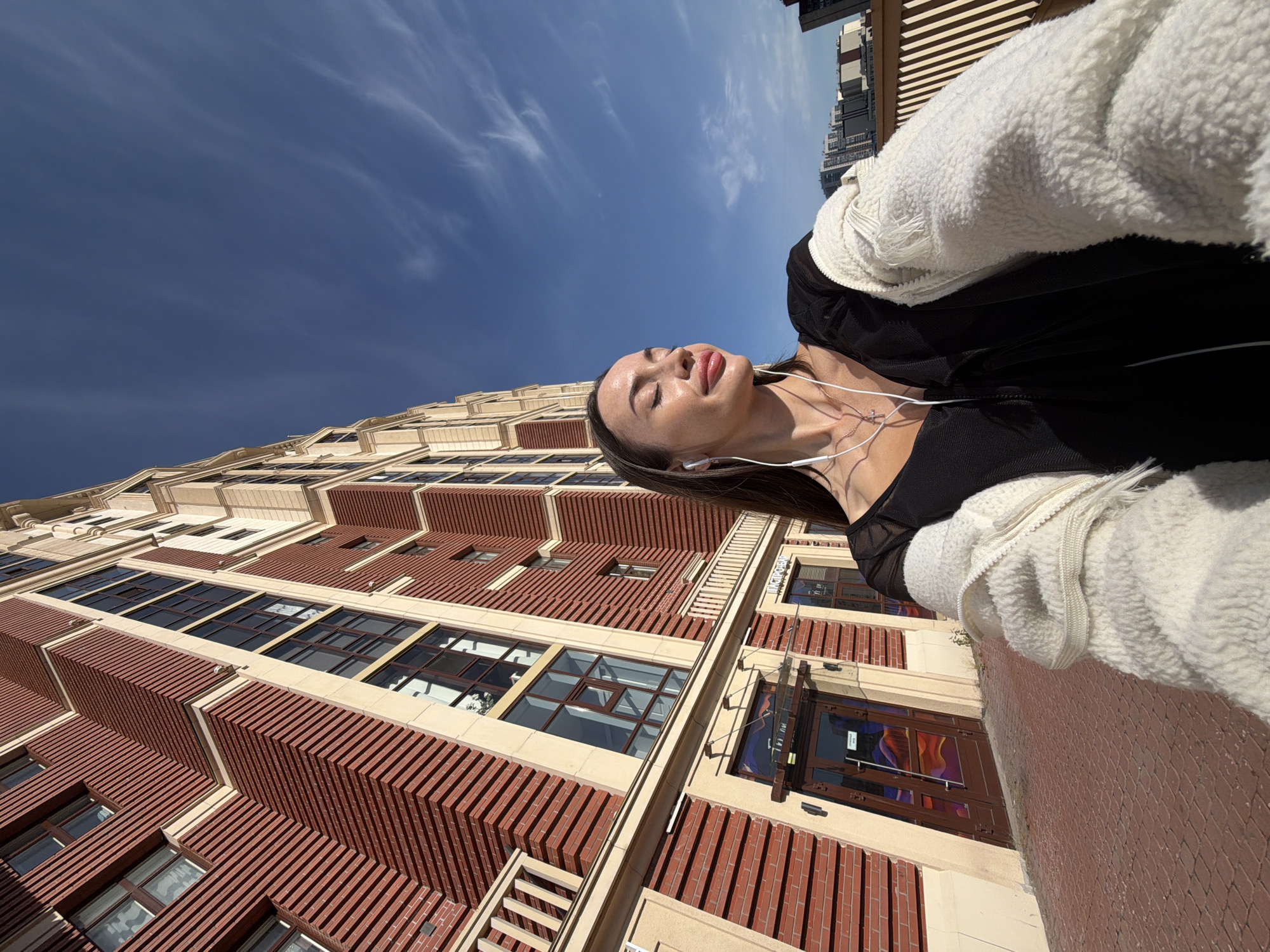 Selfies and street details outside a modern Russian building