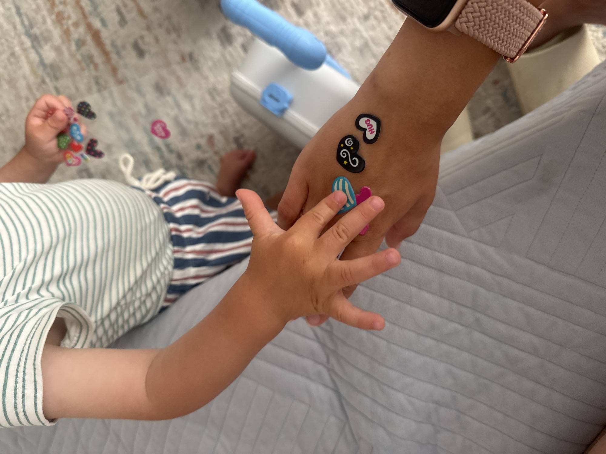 Child shares stickers with adult in Bat Yam