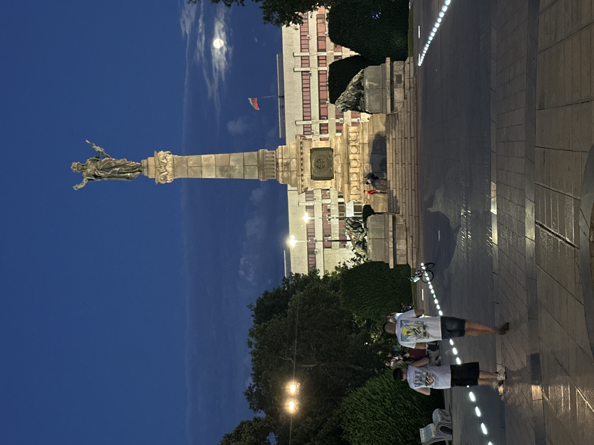 Monument and street life in central Ruse at dusk