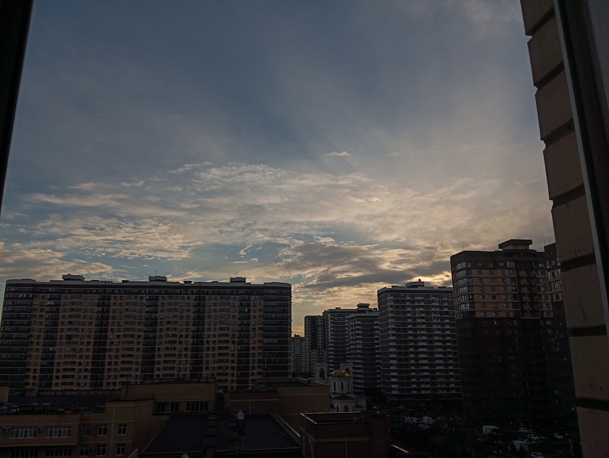 Evening domestic life documented across urban apartment district
