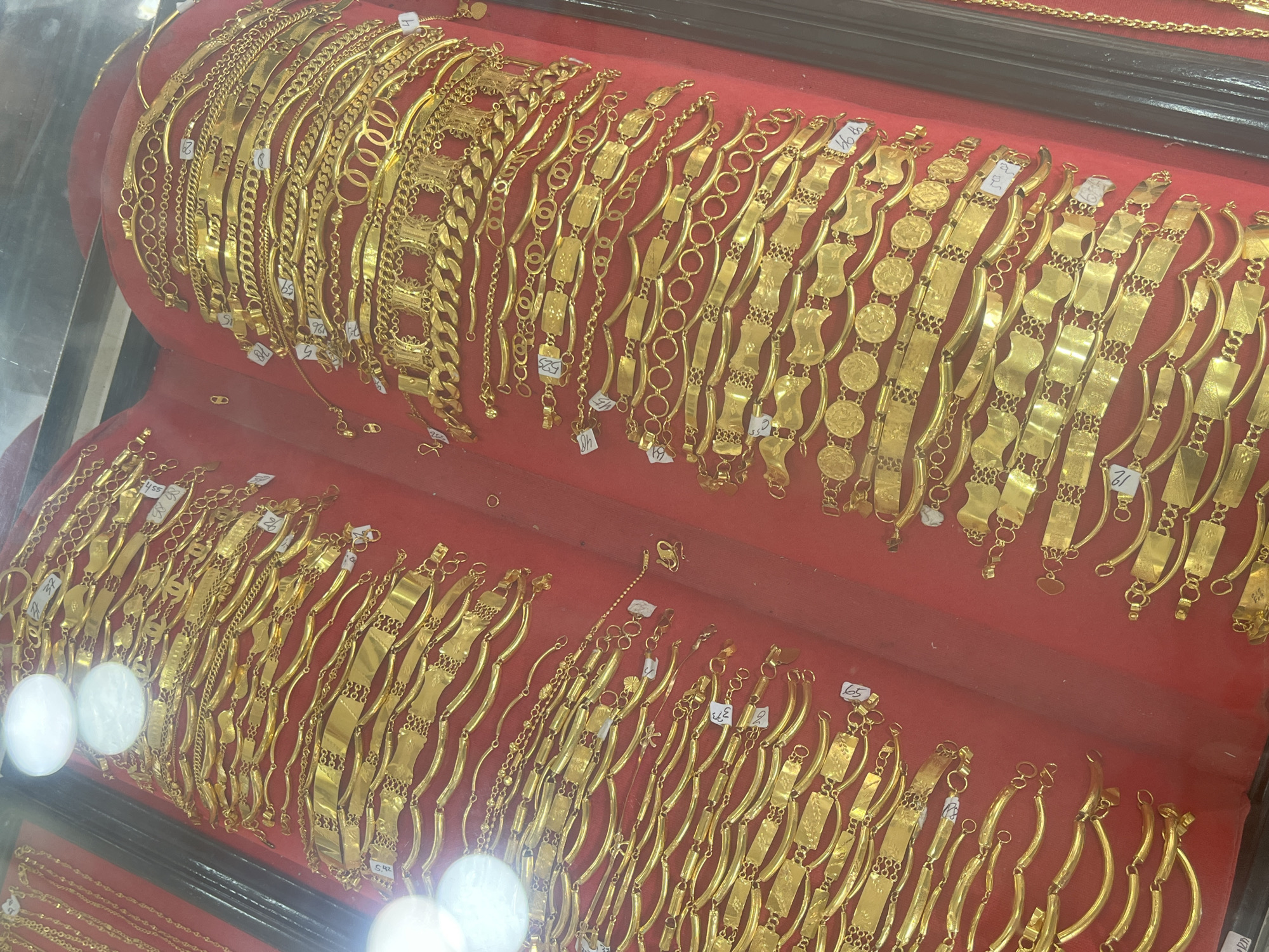 Gold jewelry and live poultry for sale at a local Indonesian market