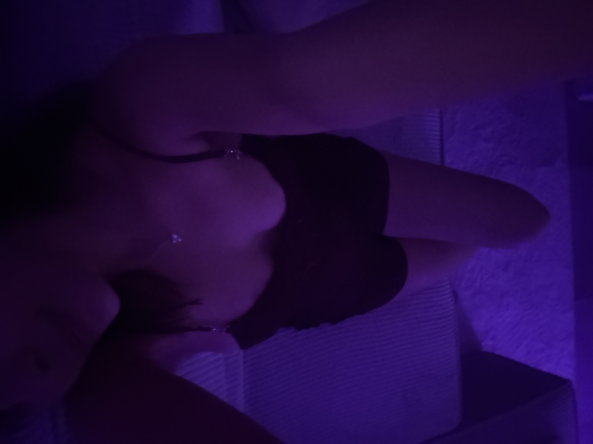 Purple-lit indoor gathering documented in Mönchengladbach evening hours