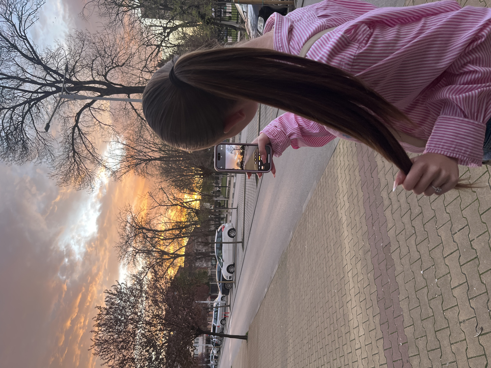Woman captures sunset photo near monument in Nova Zagora
