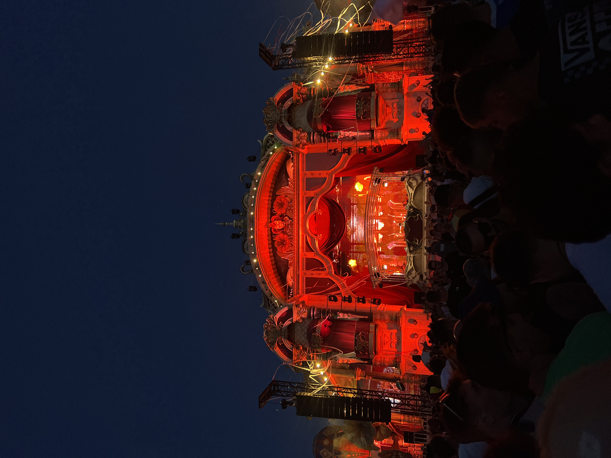 Tomorrowland's ornate red-and-gold stage draws a packed crowd at night