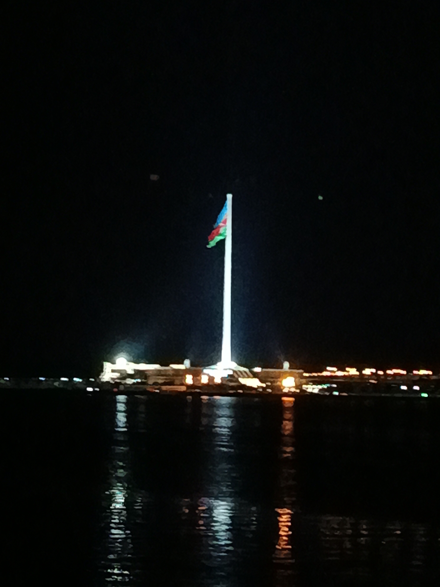 Baku Flagpole and Caspian skyline lit up at night