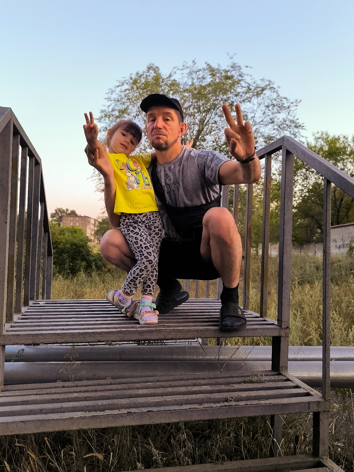Family photo session on a metal staircase in Karaganda