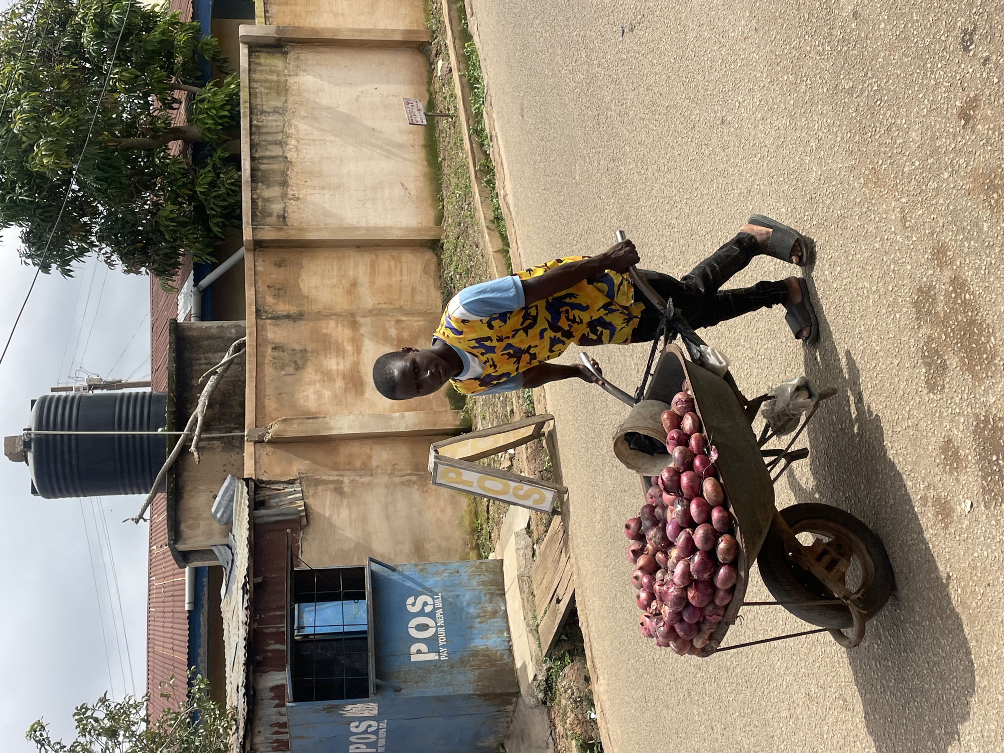 Morning street life across a Jos neighborhood