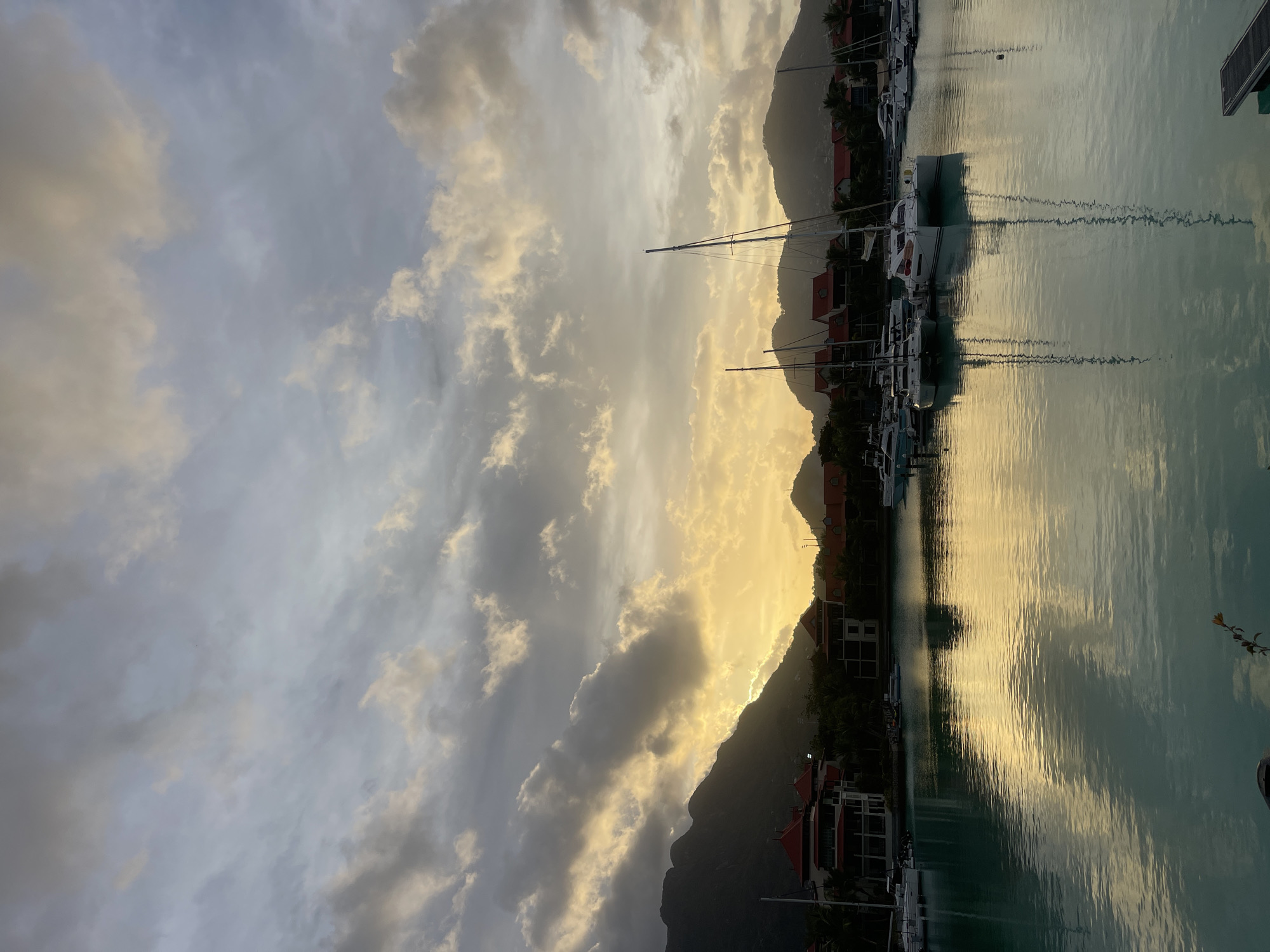 Victoria harbor glows at dusk under dramatic Seychelles skies