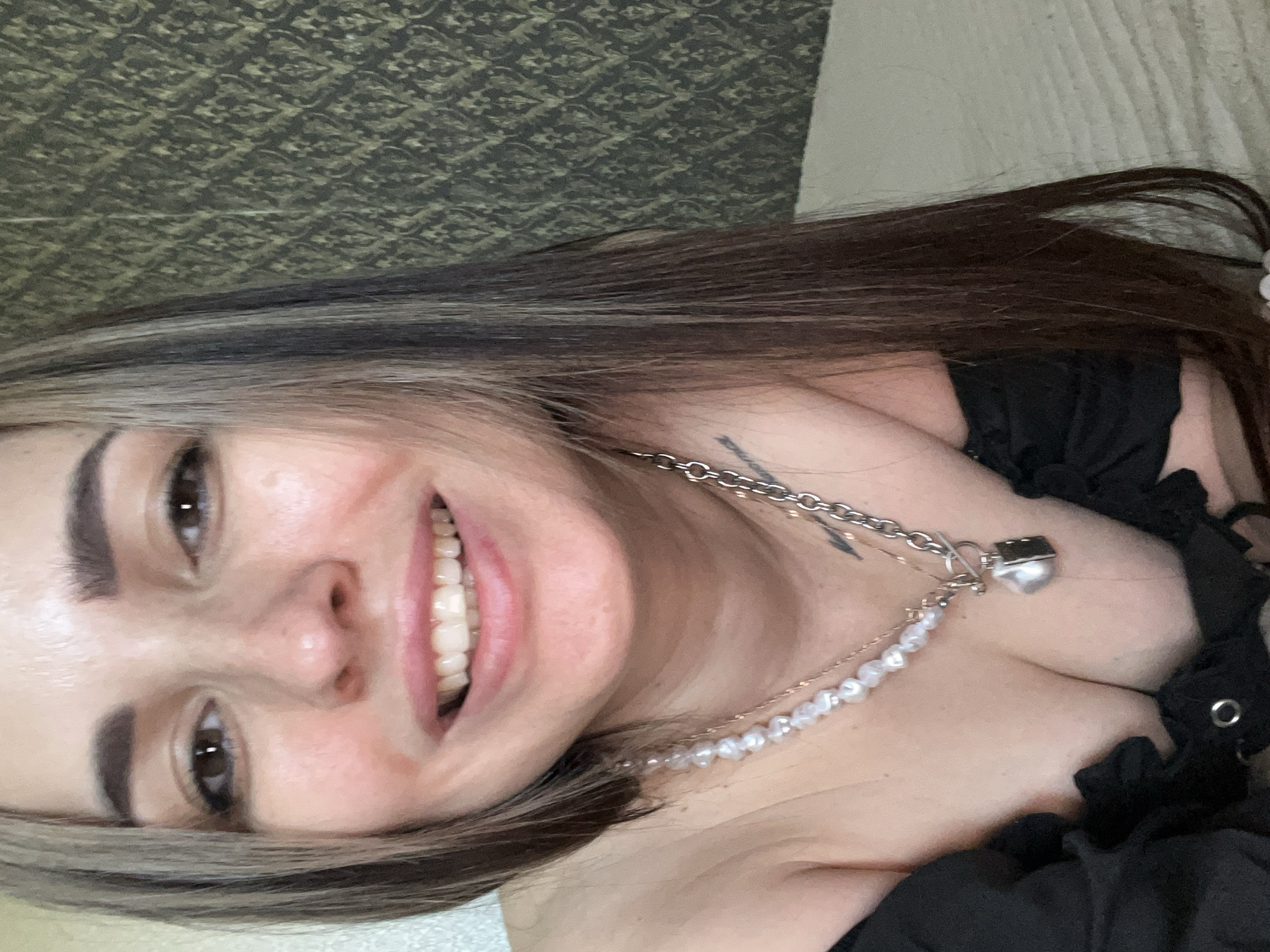 Woman in black top and pearls documented in 20 memories