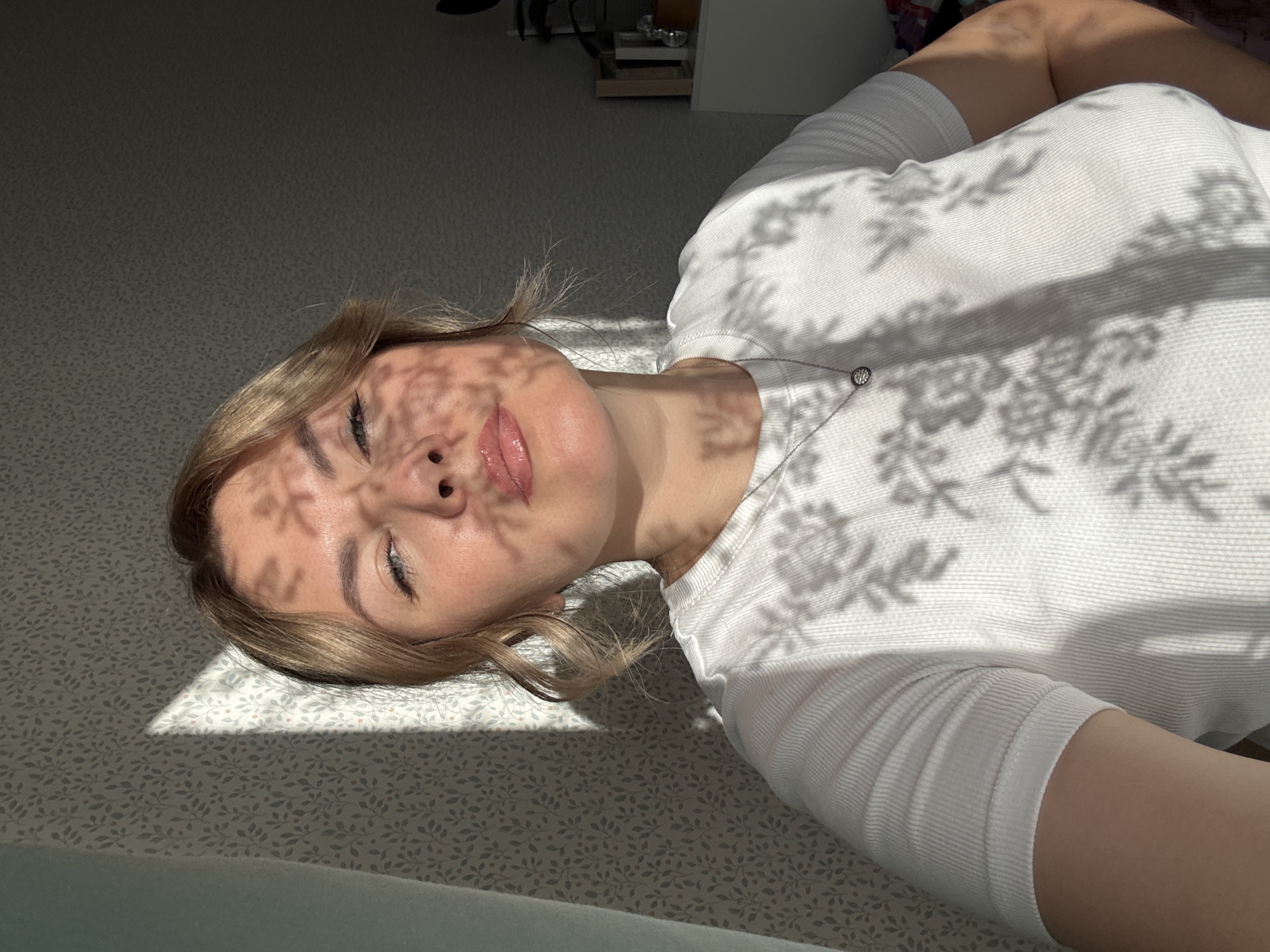 Woman rests in sunlit room in Izhevsk