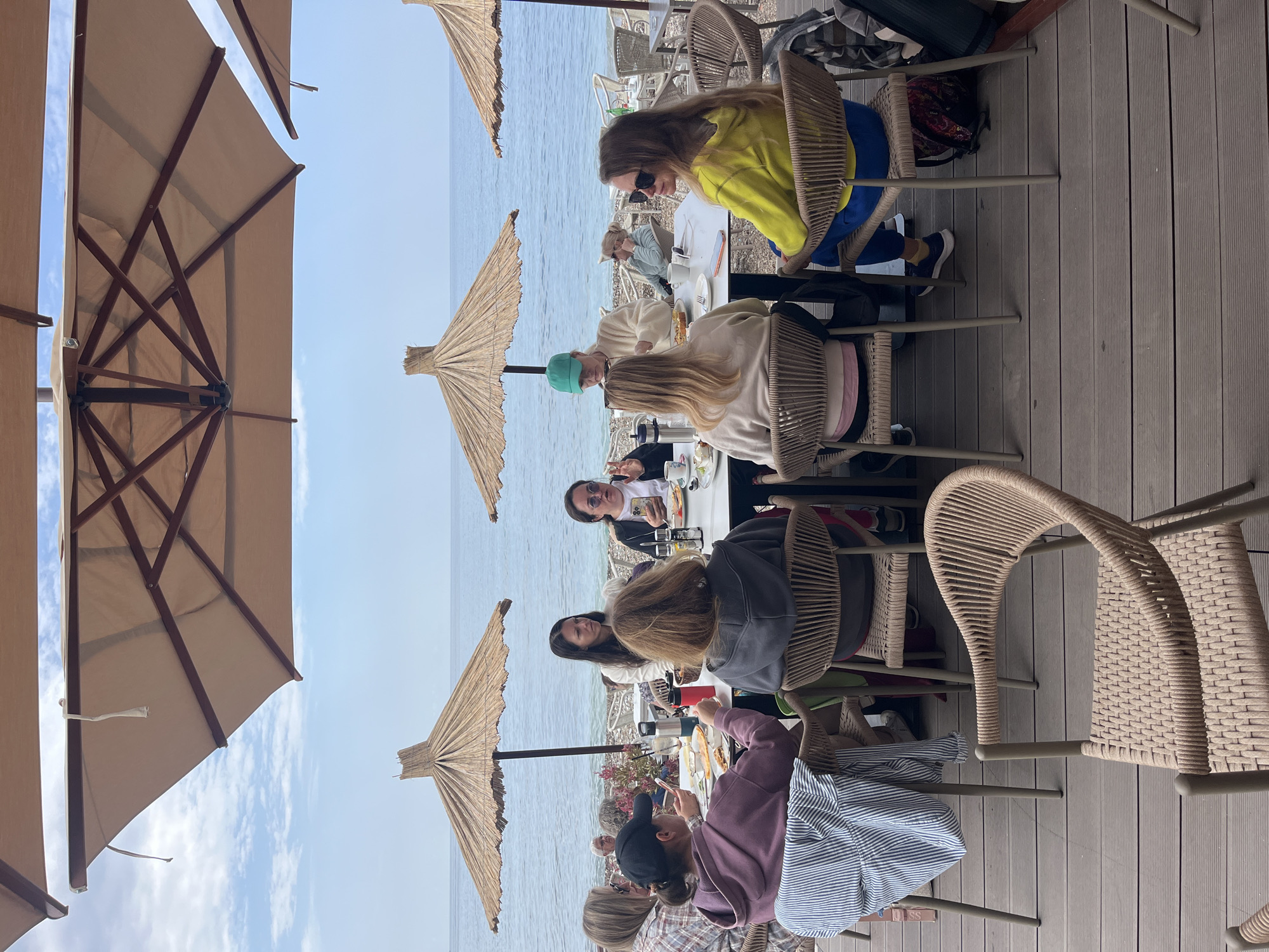 Women gather for morning meal at beachside restaurant