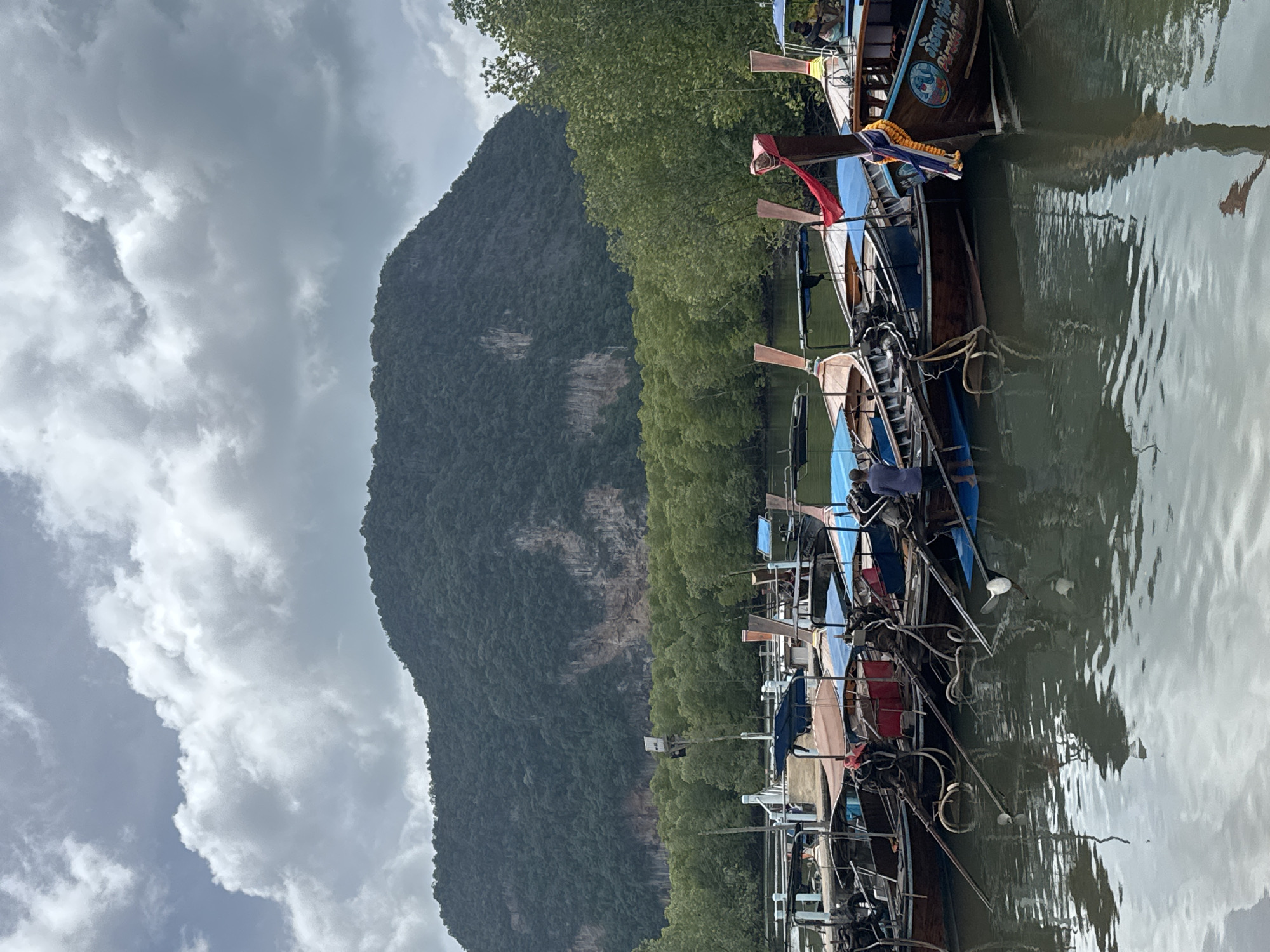 Longtail boats at a quiet pier in Ban Hin Rom, Thailand