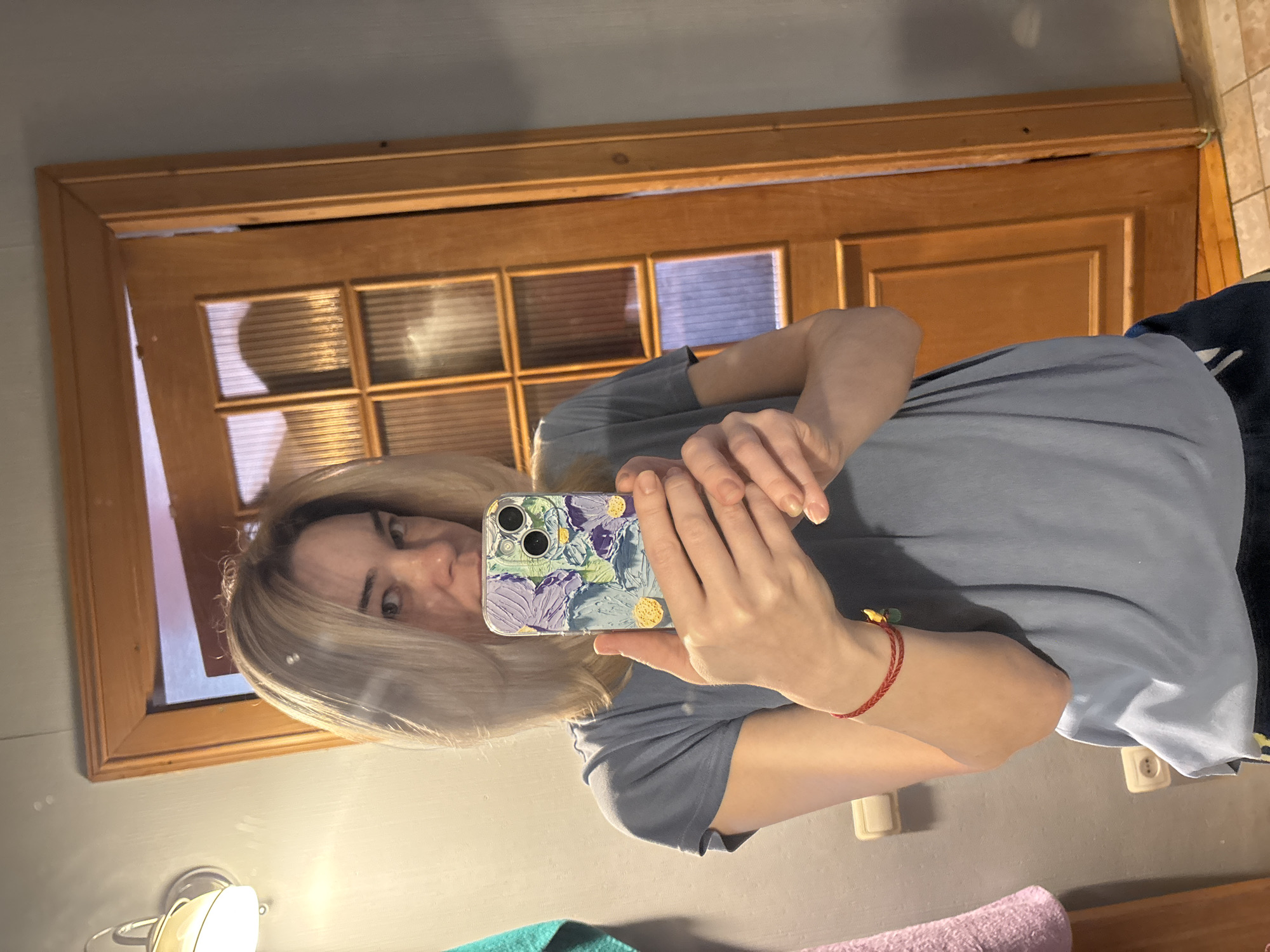 Woman Takes Multiple Selfies While Adjusting Hair Indoors