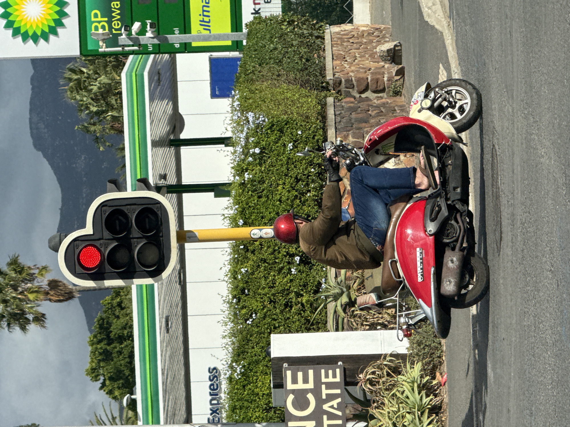Red scooter rider stops at Hout Bay traffic light