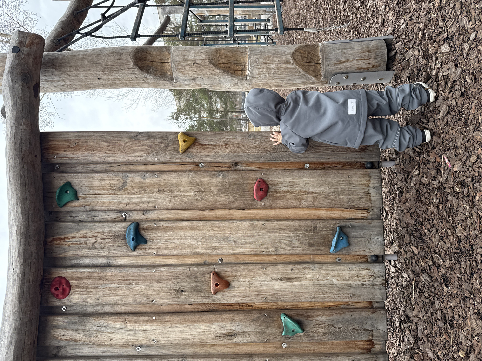 Child climbs playground wall in Krasnoyarsk