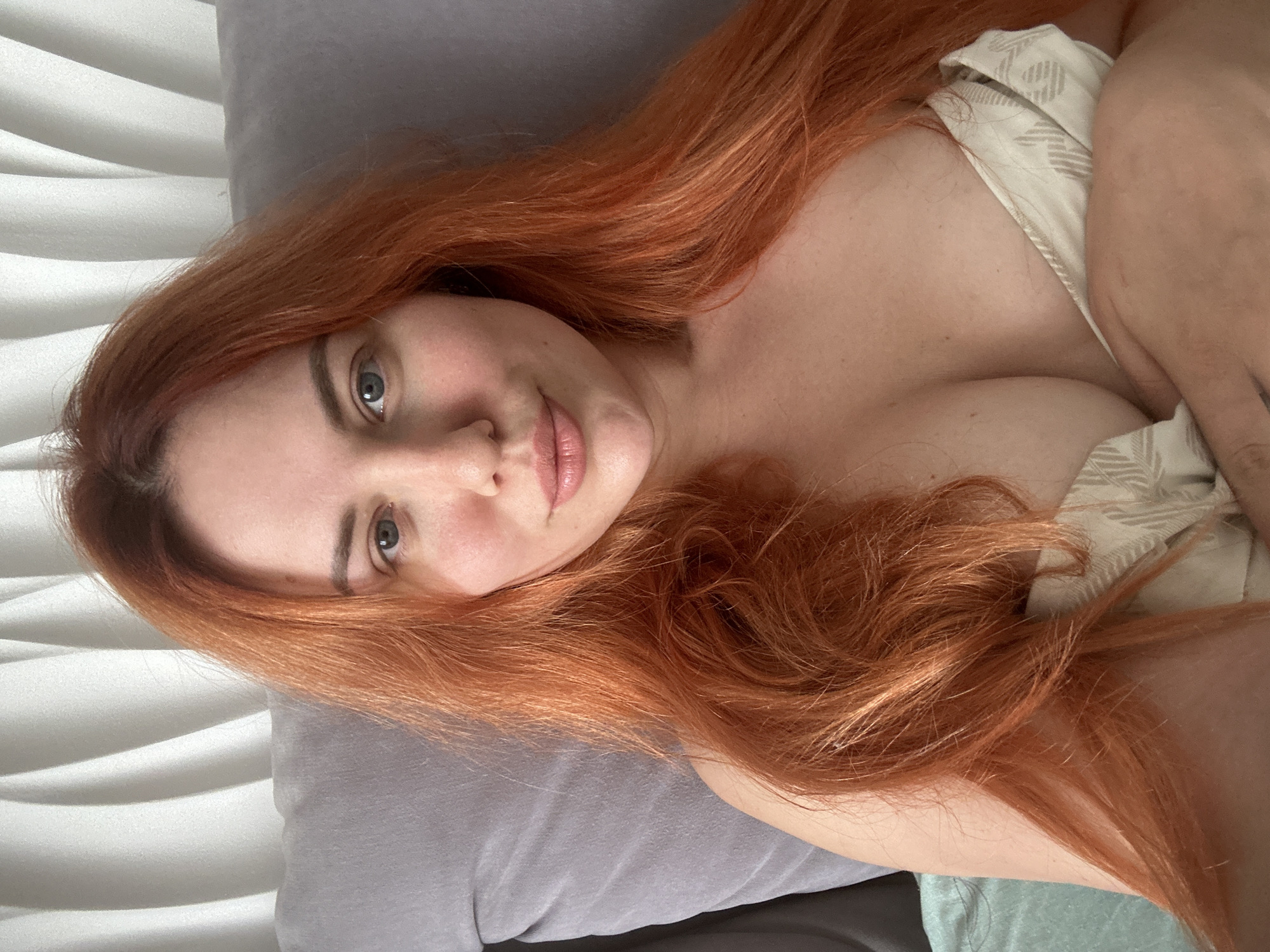 Relaxed in bed, looking at the camera