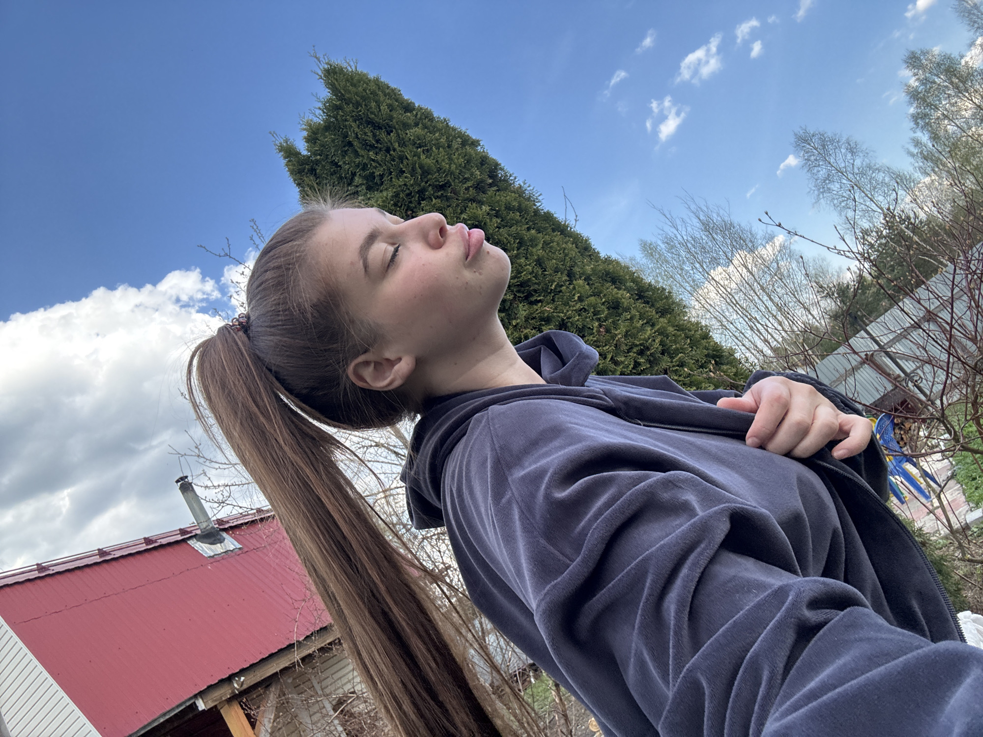 Woman enjoys sunny afternoon with pets in Russian countryside