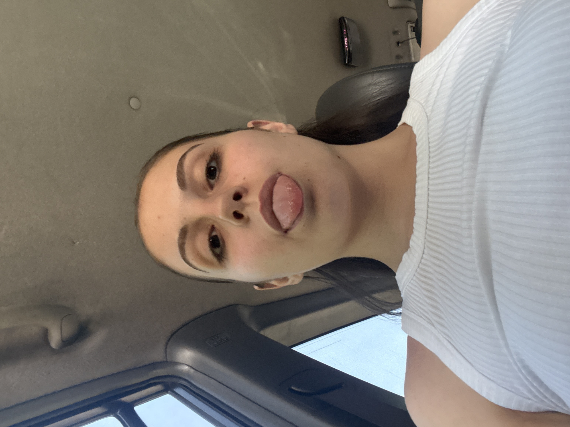 Woman takes playful selfies during vehicle travel in Burgas