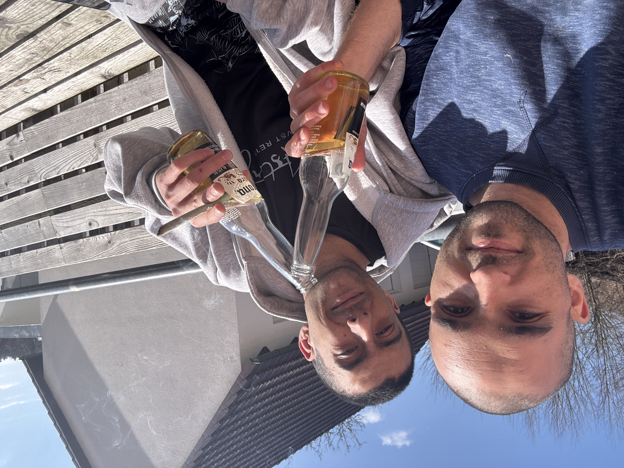 Two men take selfie with beer bottle in Wolfsegg