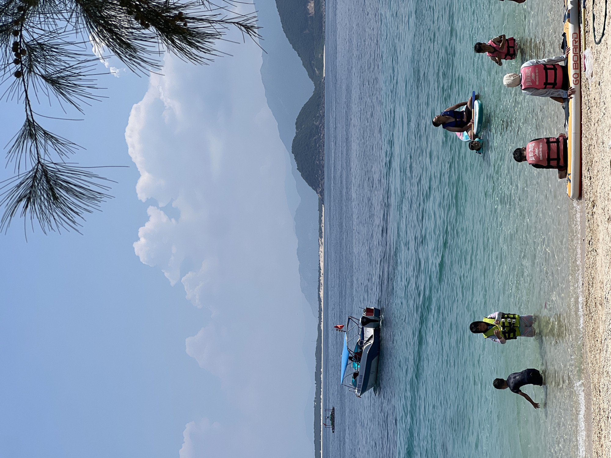 Busy morning at Dai Lanh Beach with swimmers and beach rentals
