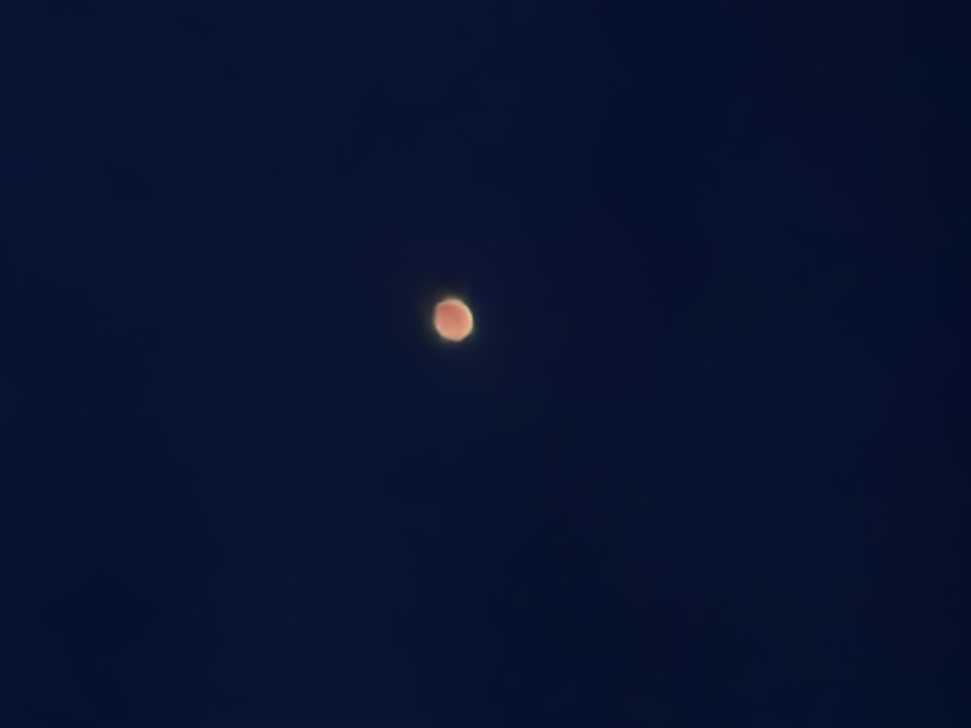 Lunar eclipse night over Warsaw, cranes and cars below