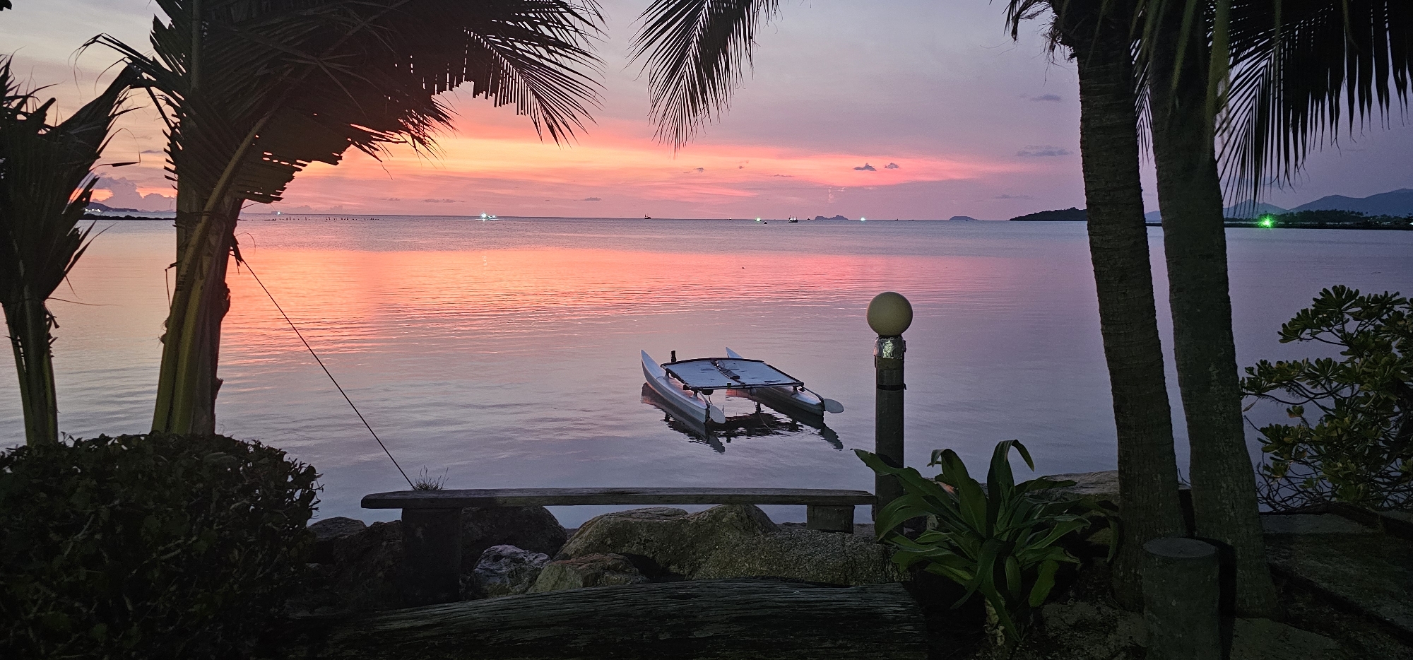 White catamaran anchored in calm Thai coastal waters