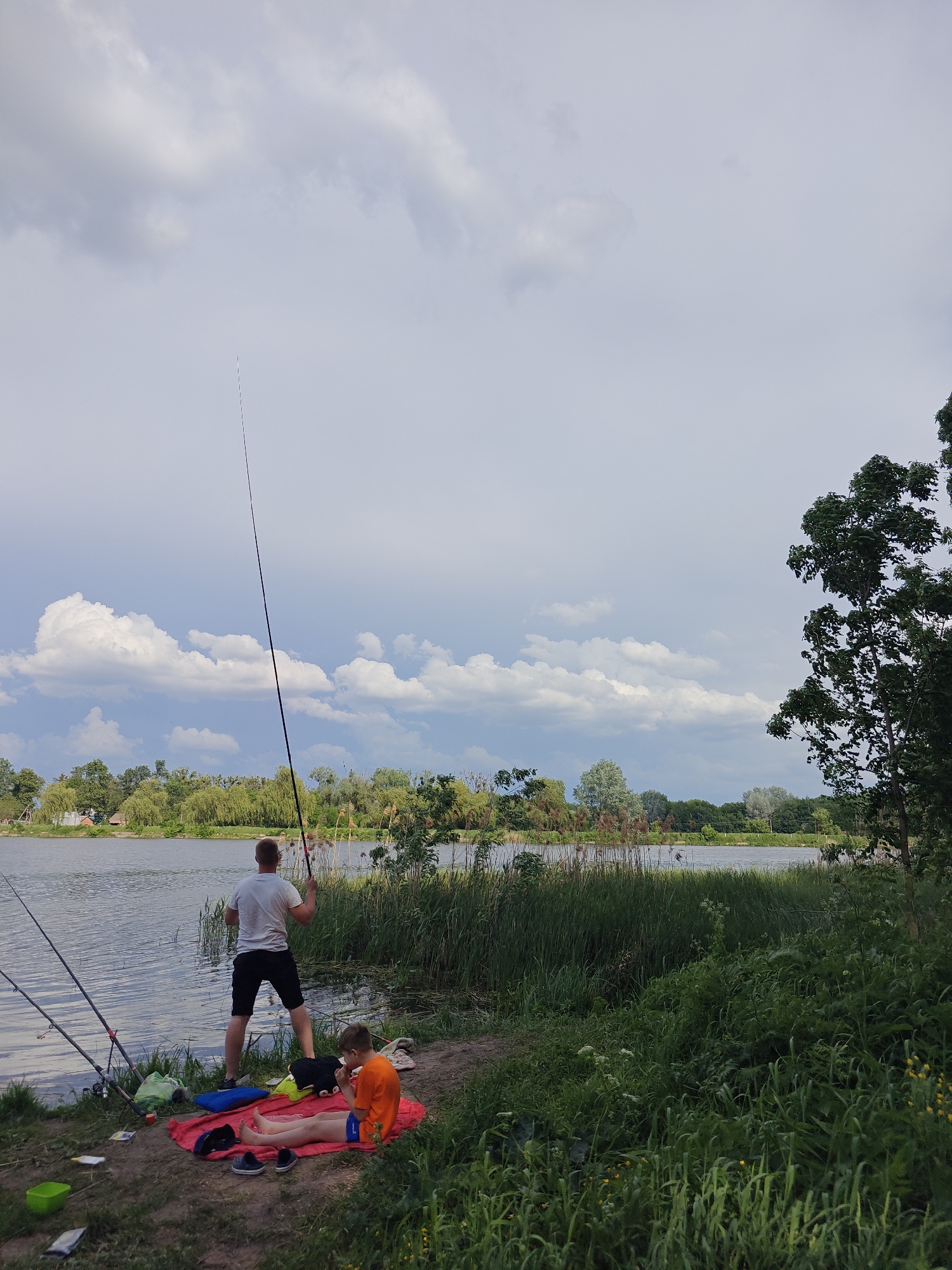 Father and son fishing trip at Ukrainian lake