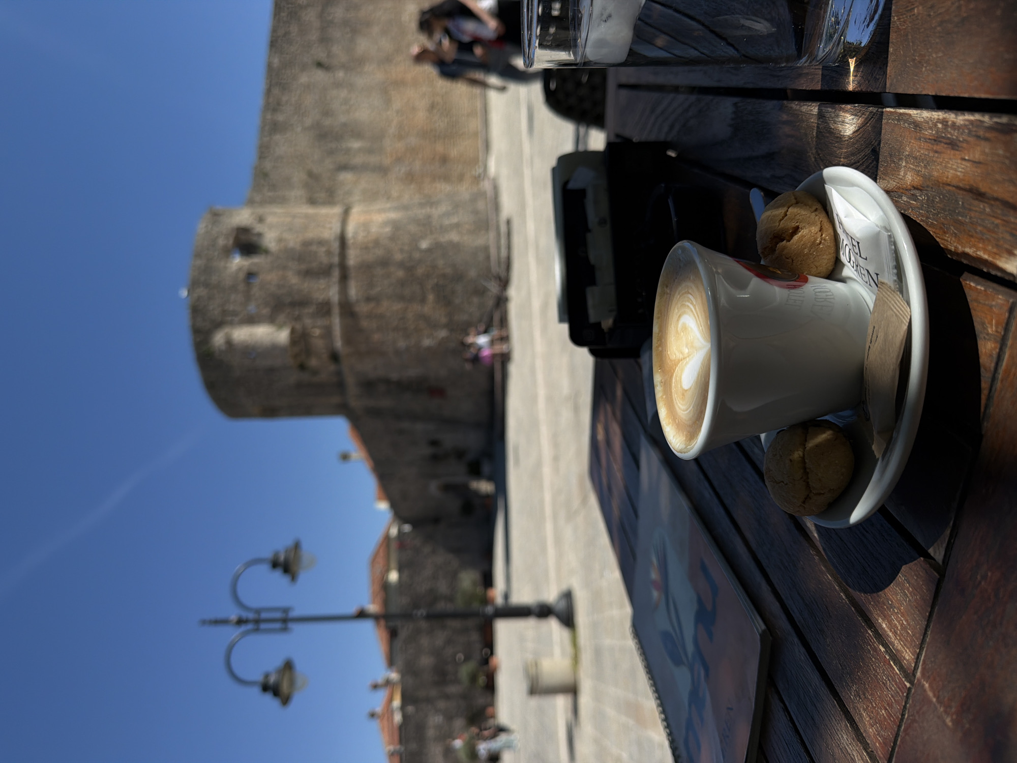 Coffee break documented at historic Budva cafe near ancient walls