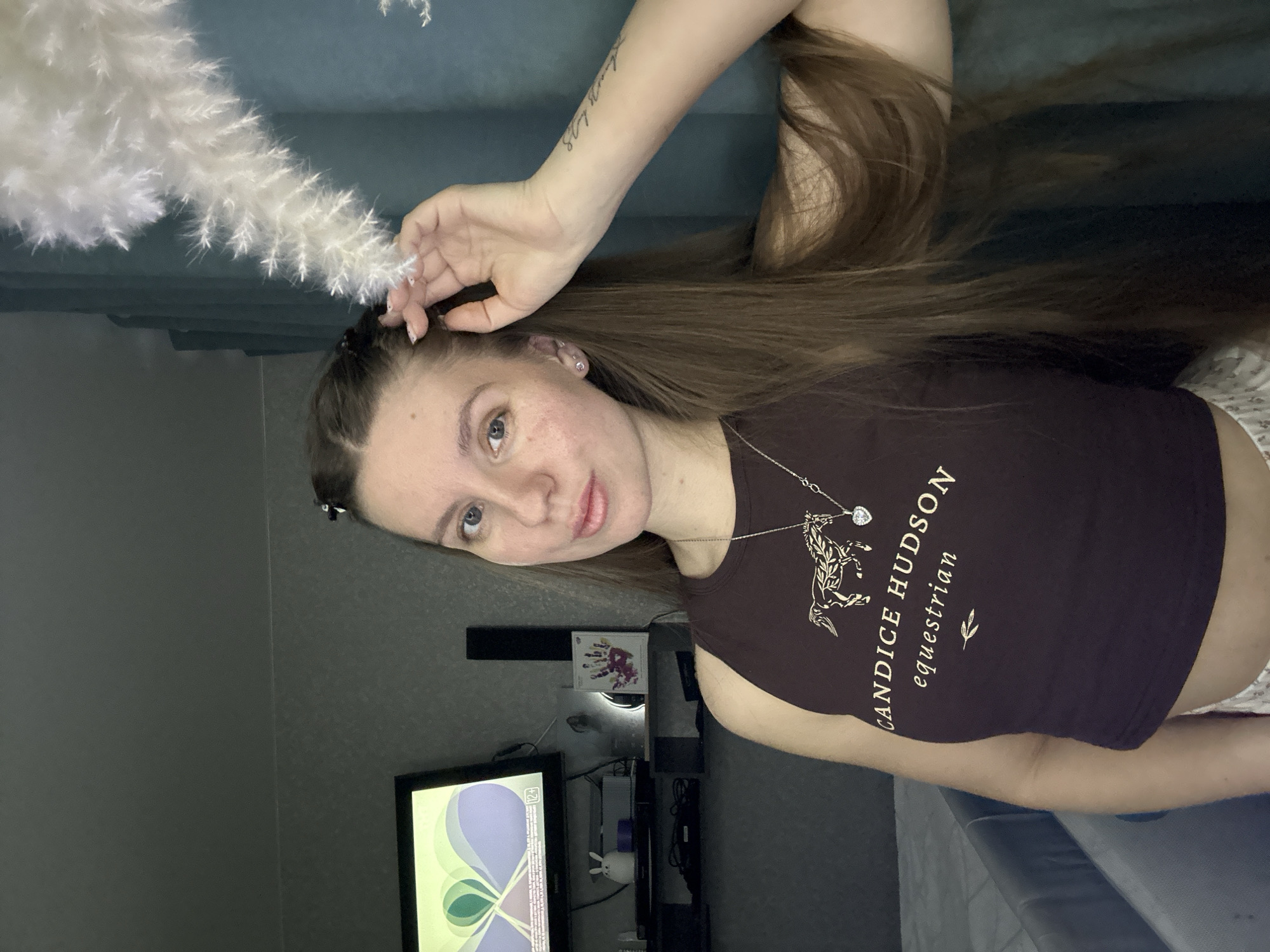 Woman photographs herself indoors during evening in Klin, Russia