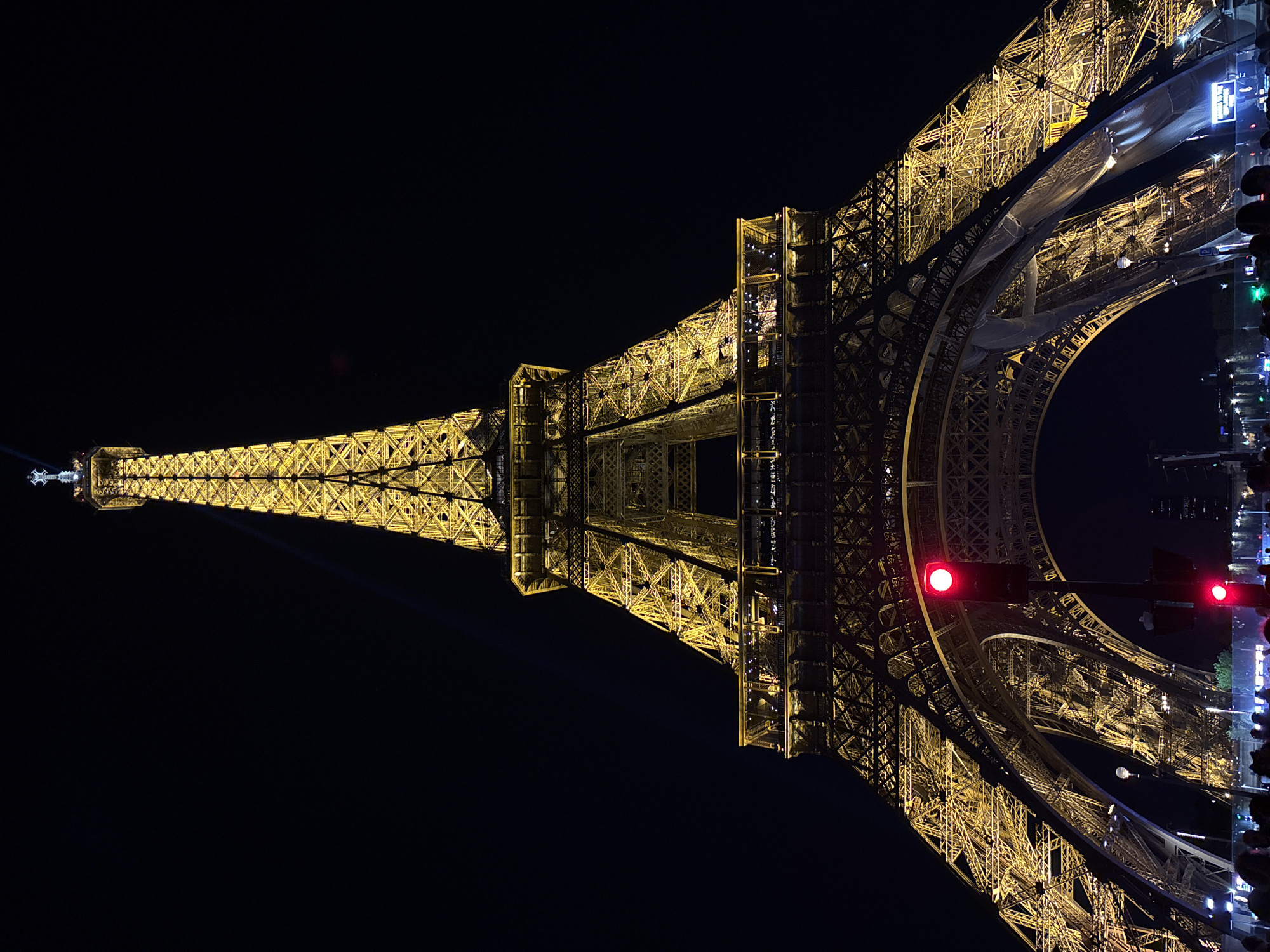 Eiffel Tower glows yellow in evening illumination display