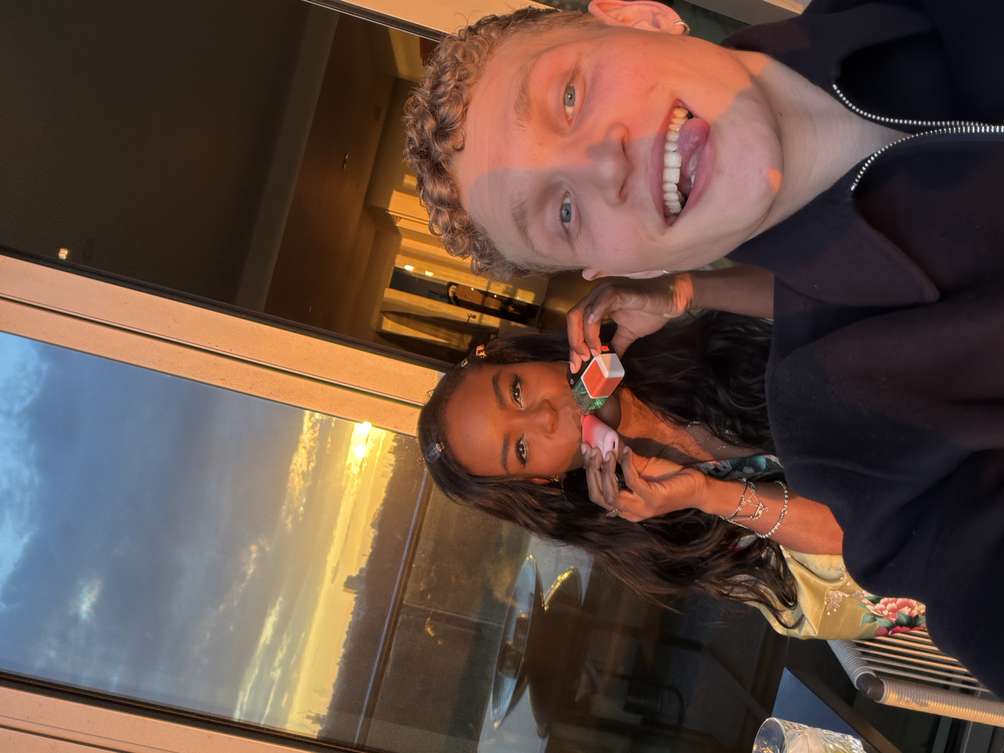 Person takes selfie from elevated London viewpoint at sunset