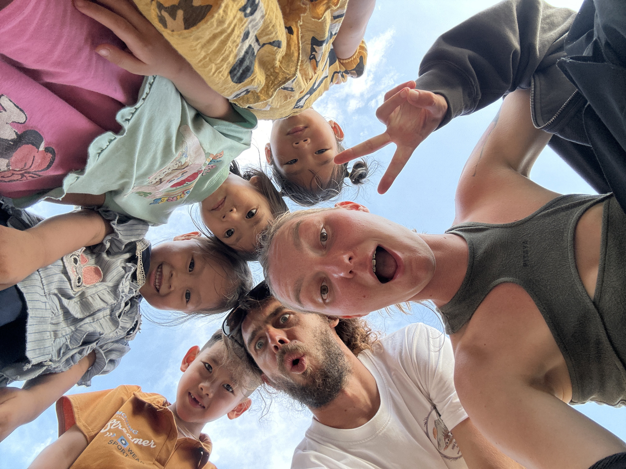 Family group gathers for playful photos in rural Vietnam