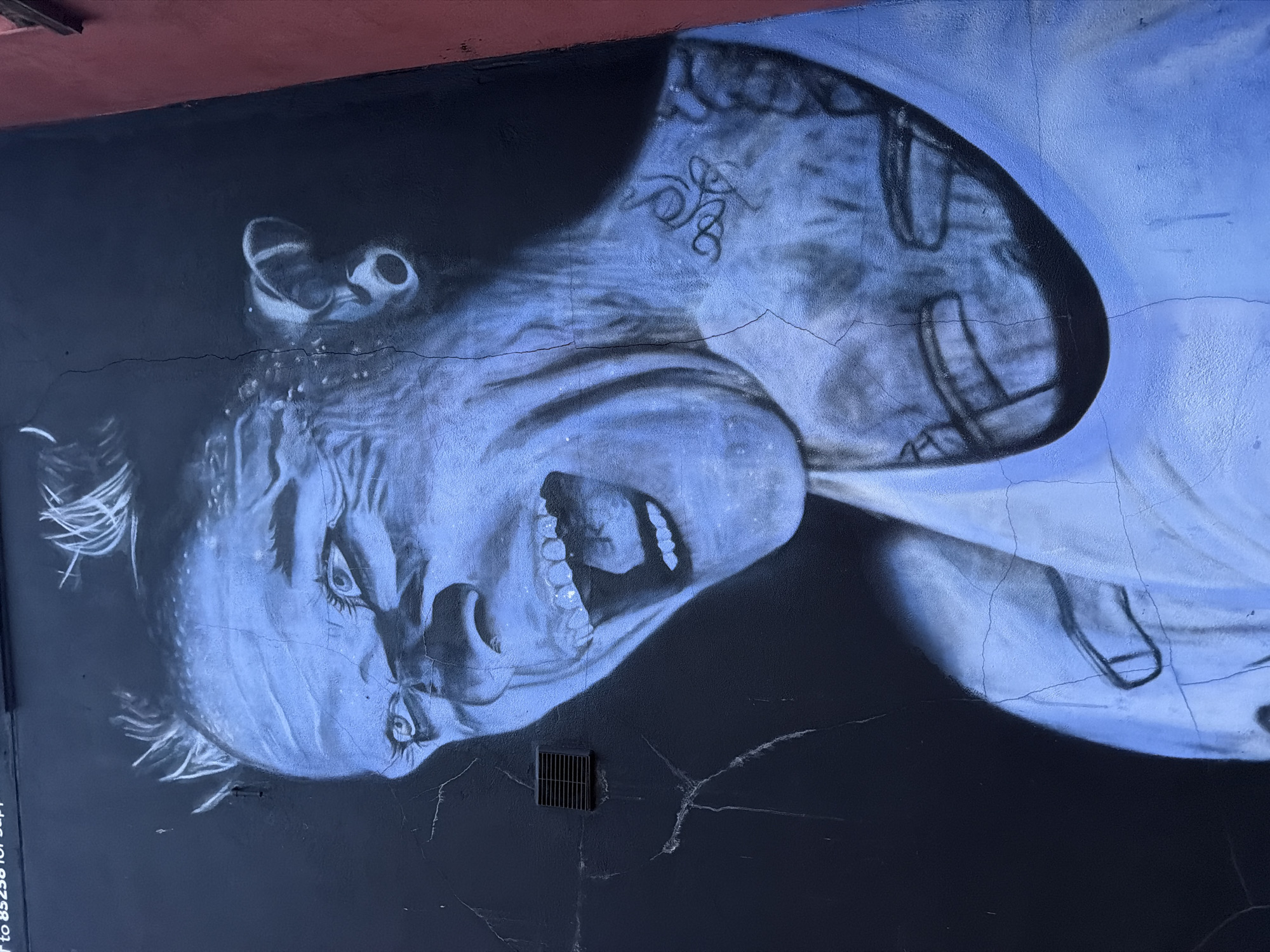 Distressed face mural spotted on London wall