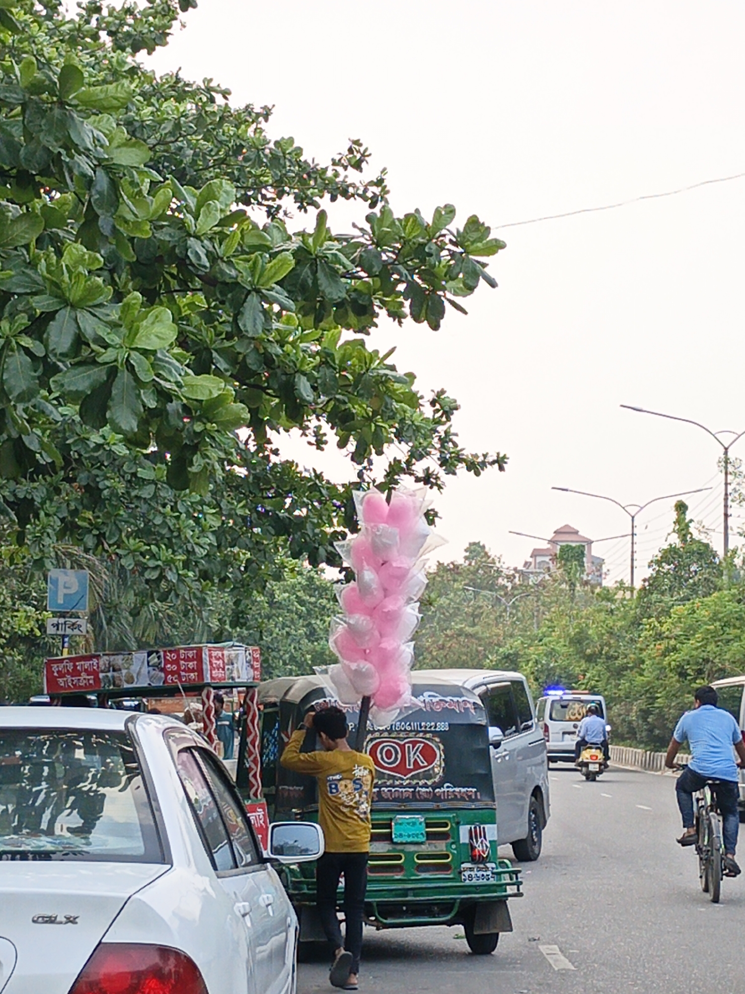 Dhaka street scenes show vendors, roadwork, abandoned vehicles