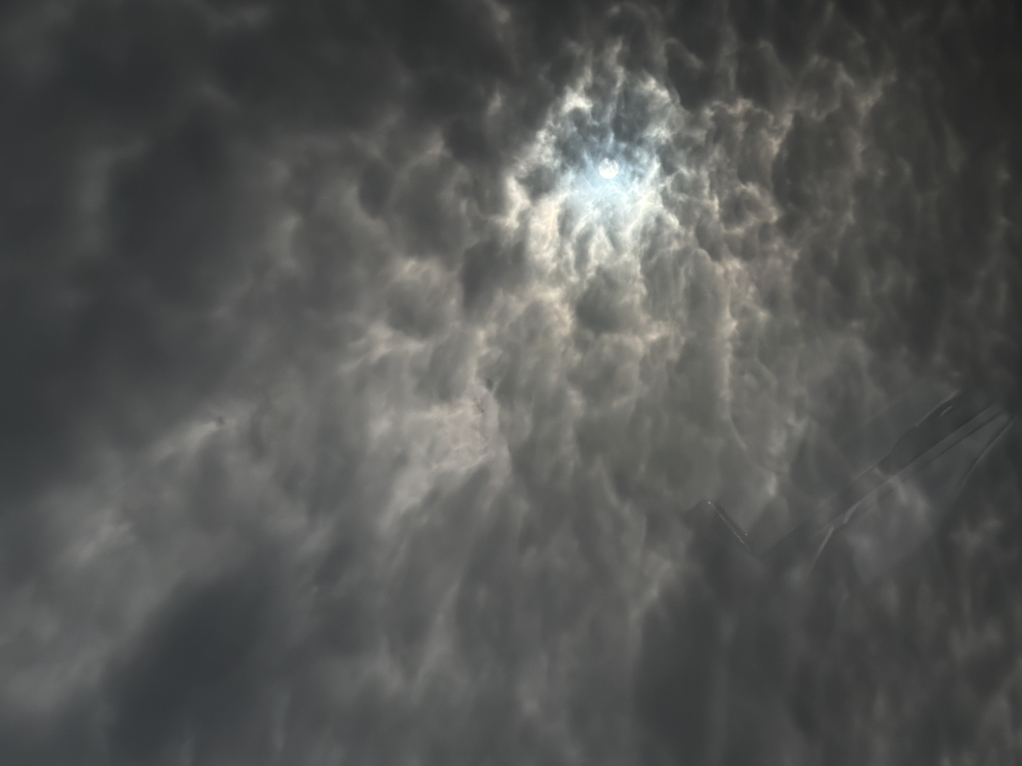 Aircraft spotted through dramatic overcast skies in Jouy-le-Moutier