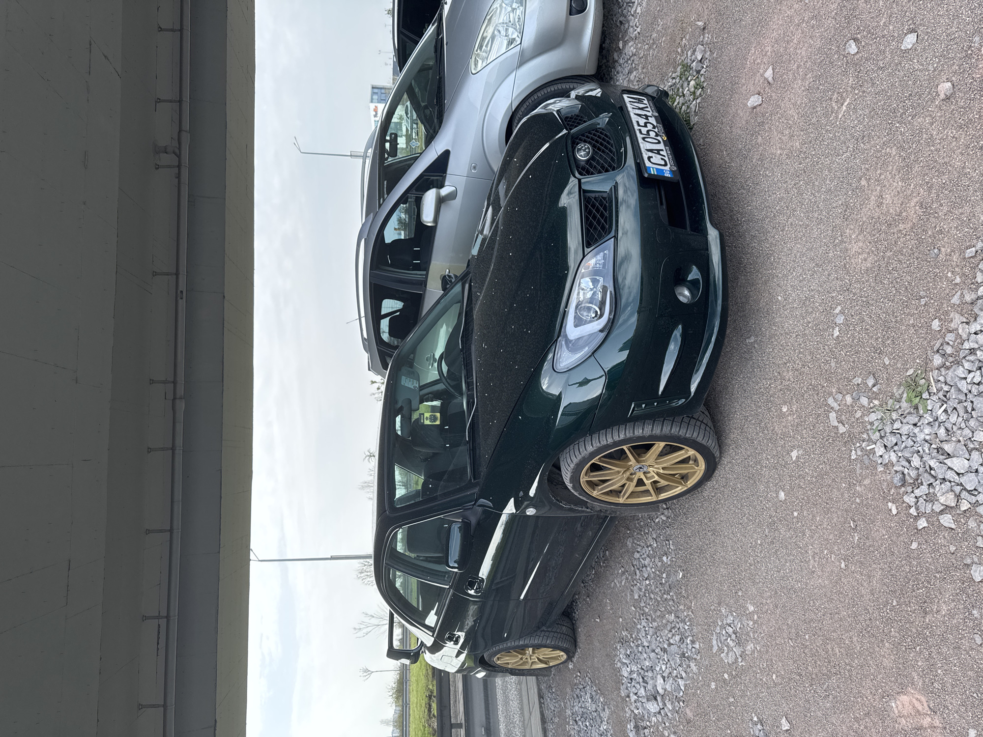 Green Subaru with gold rims spotted under Sofia overpass