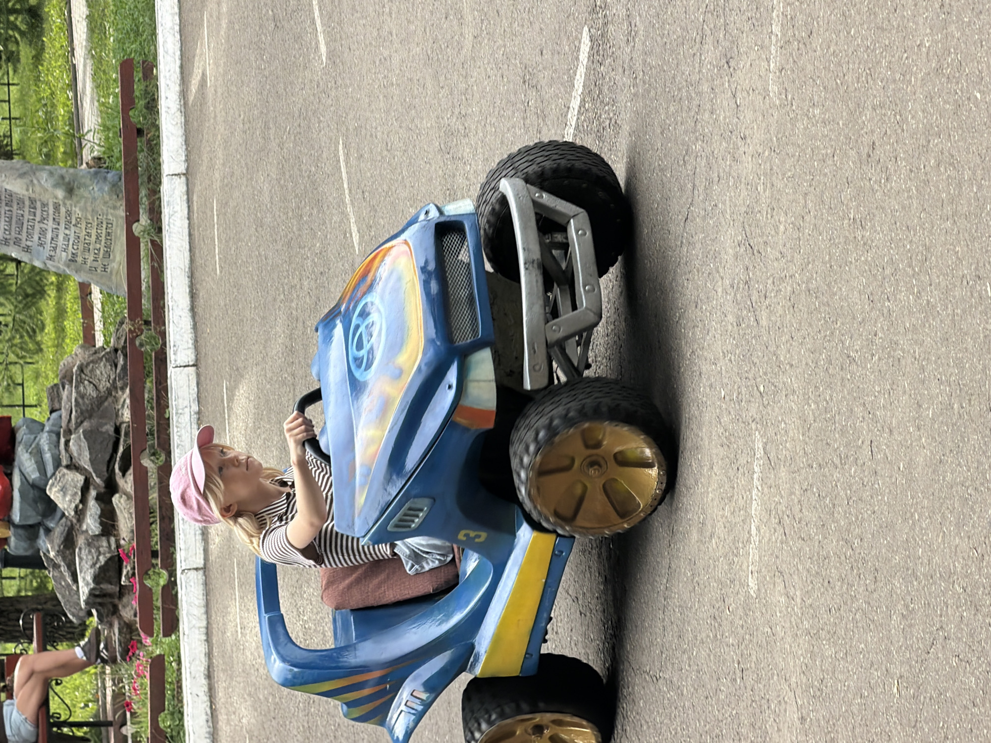 Kids' toy cars and a mini train at a Chaikovsky park