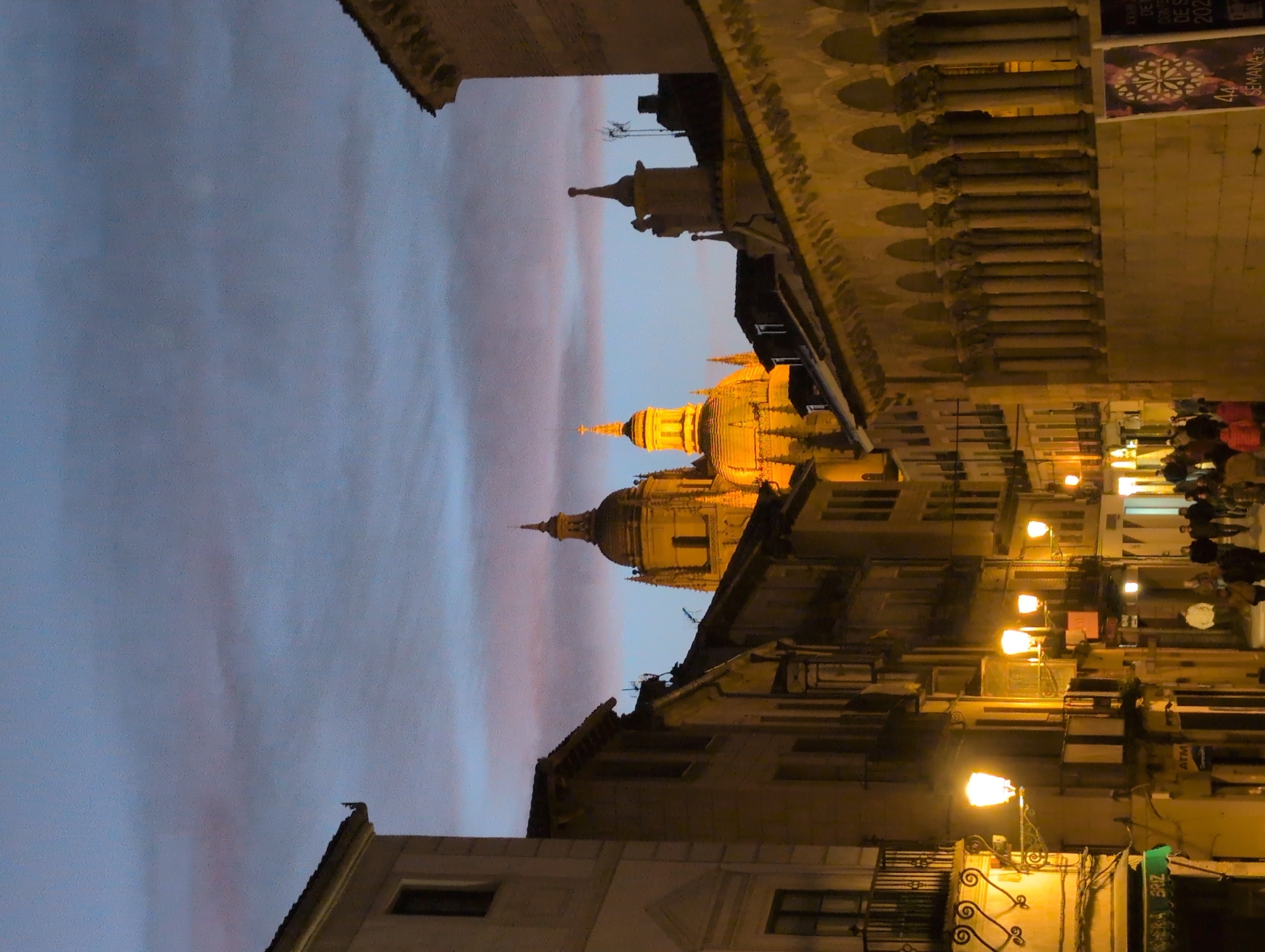 Segovia Cathedral dome illuminated against colorful dusk sky