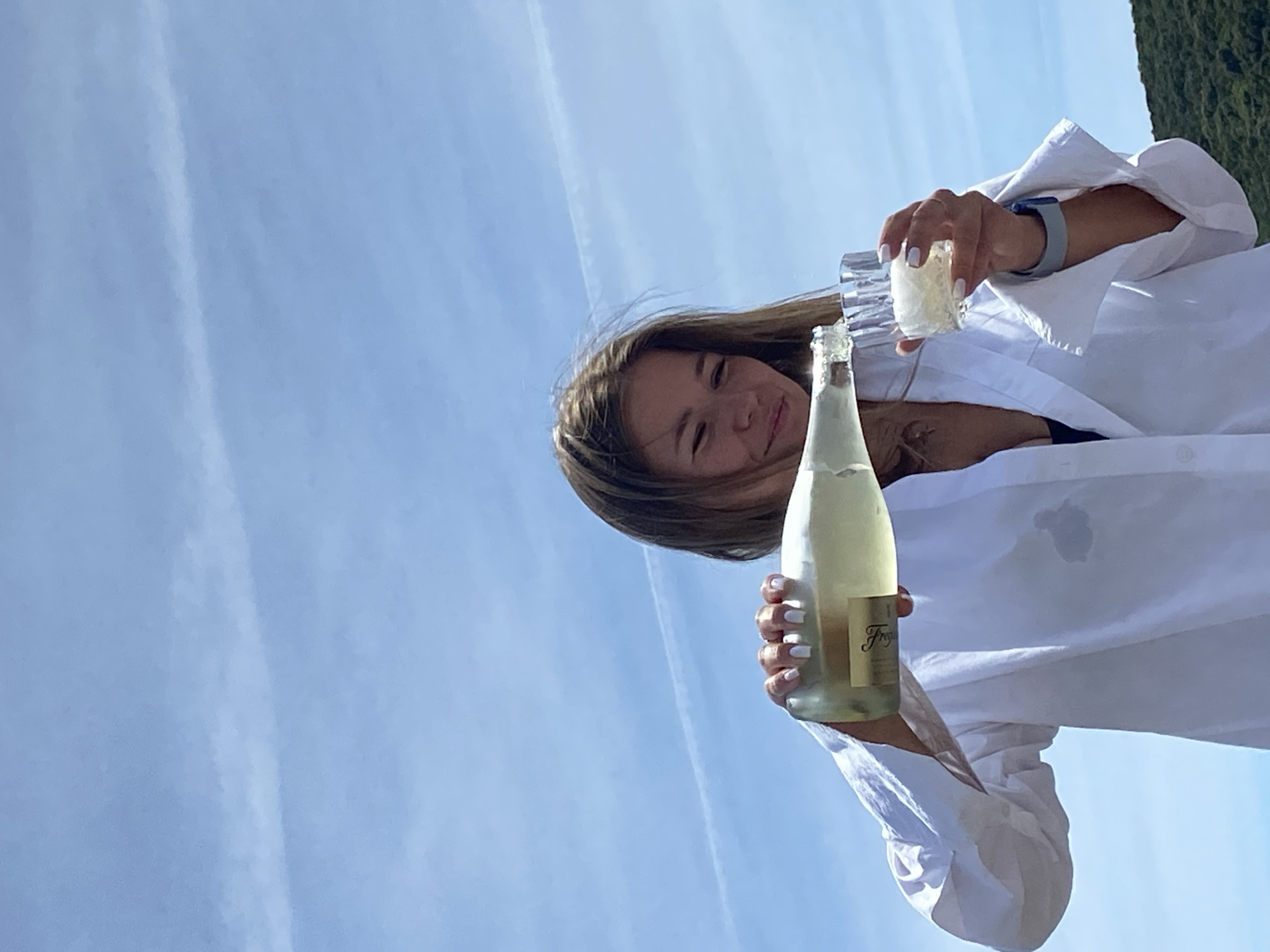 Woman enjoys sparkling wine on Montenegro beach