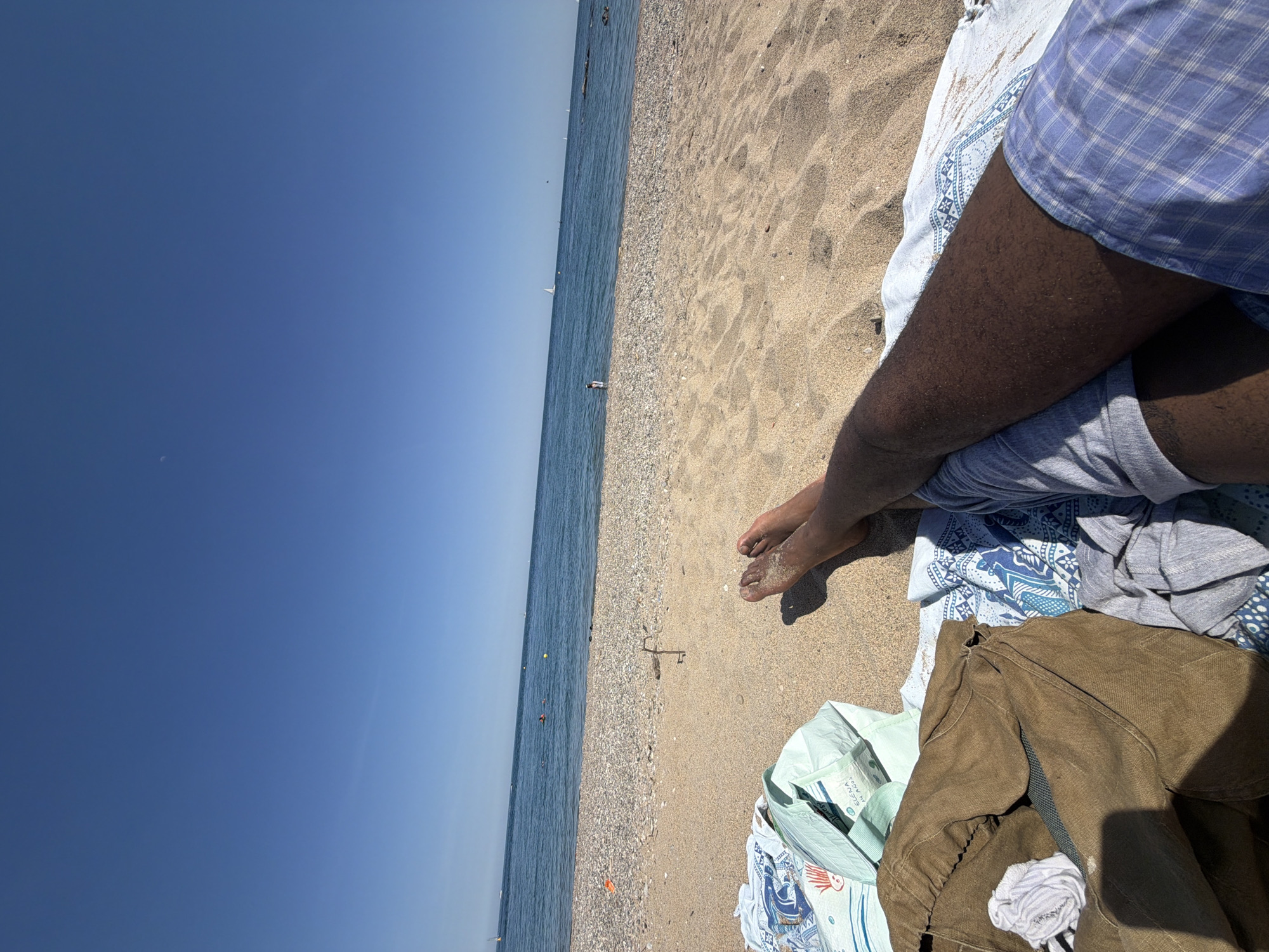 Beachgoer enjoys clear day at Sant Adrià de Besòs Mediterranean shore